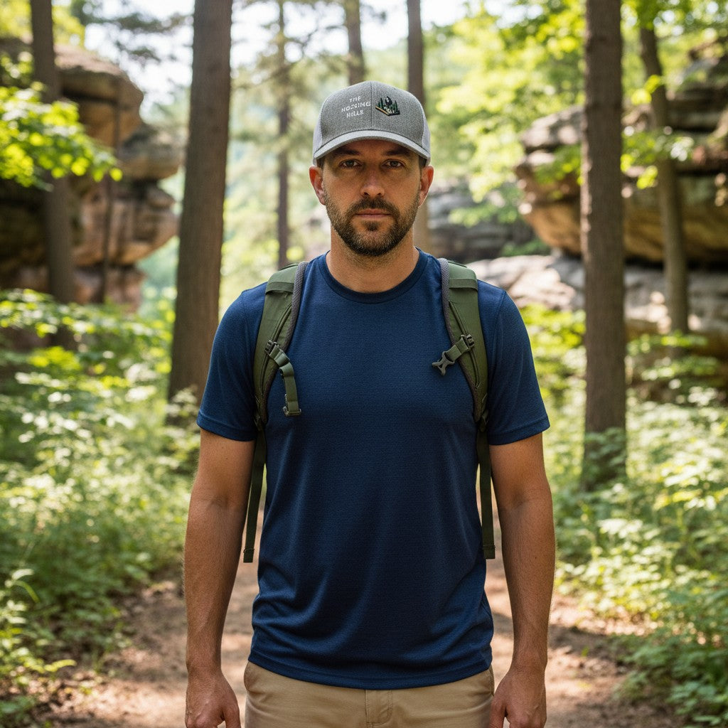 The Hocking Hills Store grey trucker hat with white mesh back, embroidered with "The Hocking Hills" and a Bigfoot graphic.