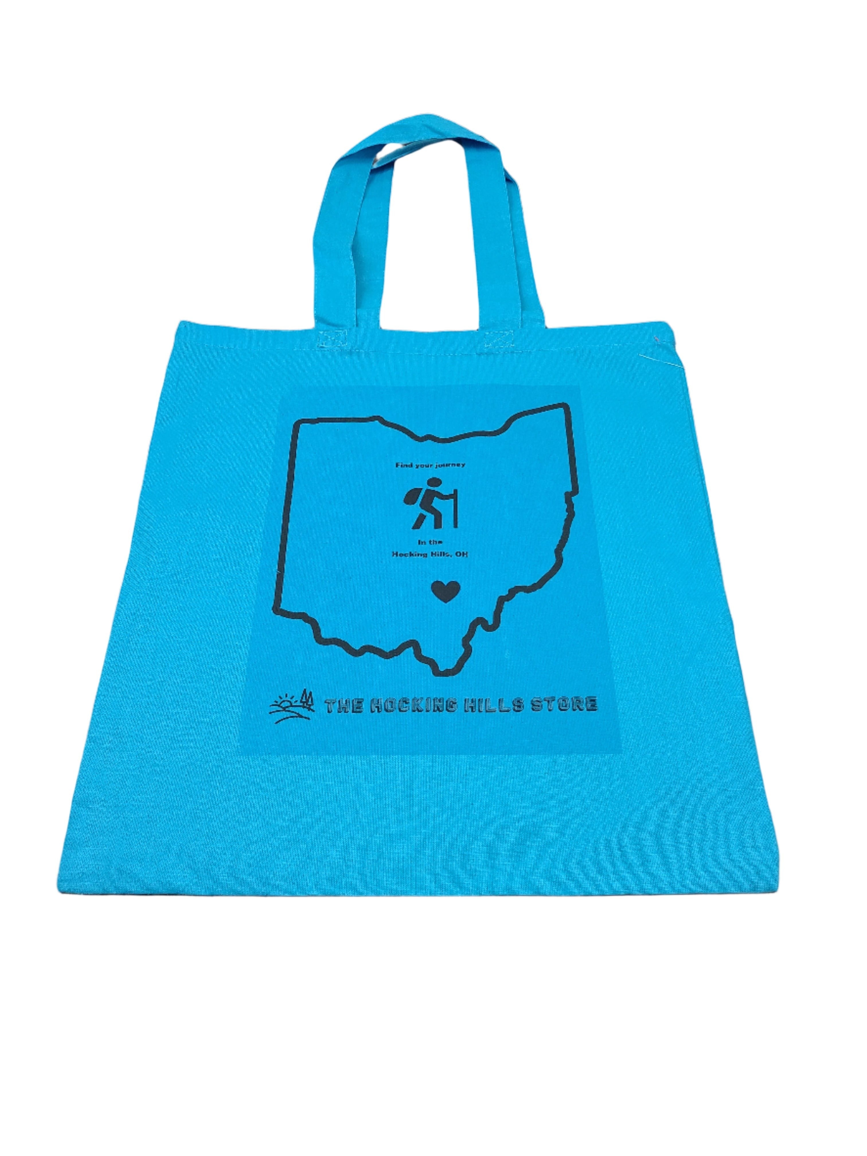 The Hocking Hills Store blue canvas tote bag with Ohio outline graphic and hiking icon.