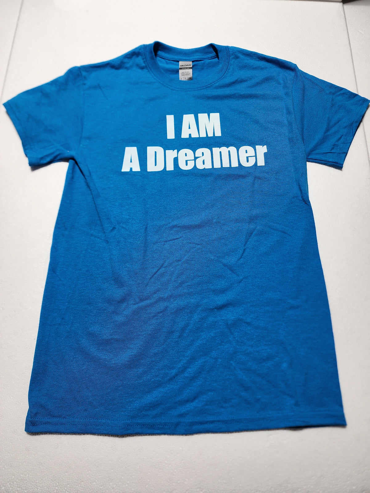 The Hocking Hills Store blue I Am A Dreamer graphic t-shirt with white minimalist text on a soft cotton fabric.