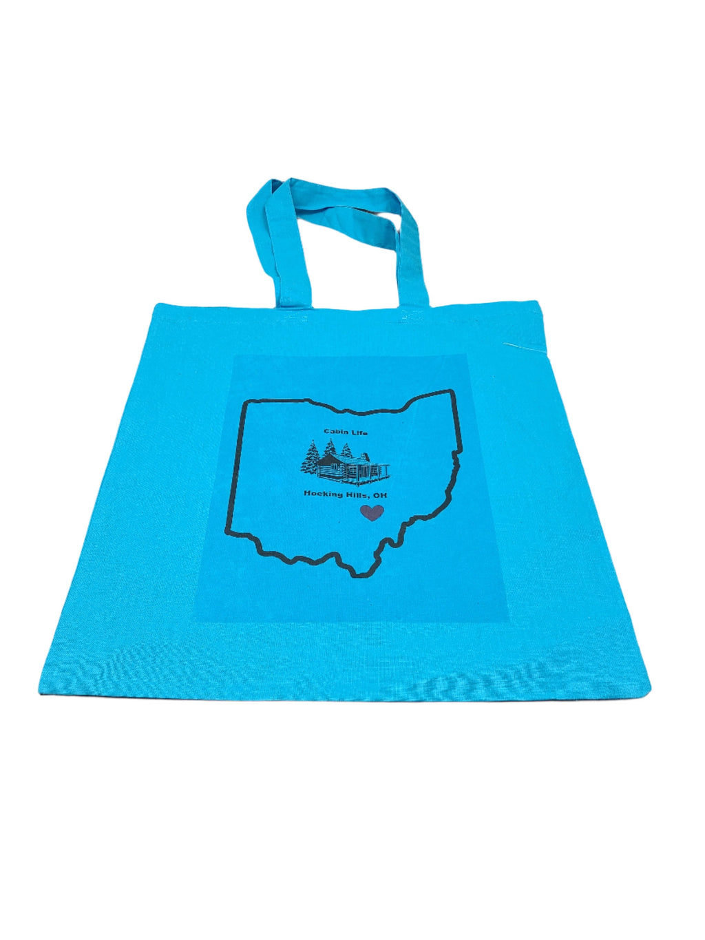 The Hocking Hills Store blue canvas tote bag with Ohio outline graphic and cabin illustration.