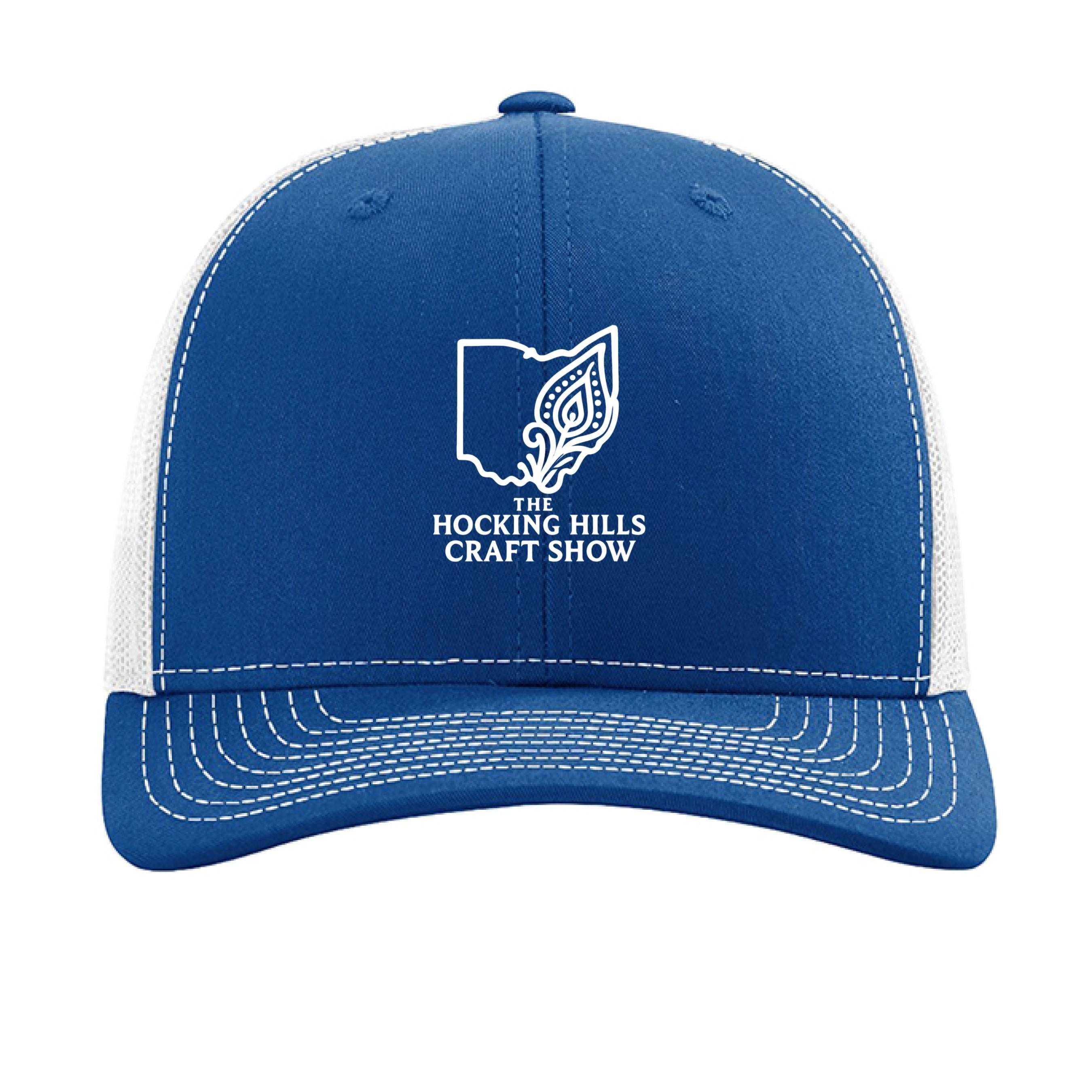 The Hocking Hills Store blue and white trucker hat with "The Hocking Hills Craft Show" logo. Cotton front, polyester mesh back.