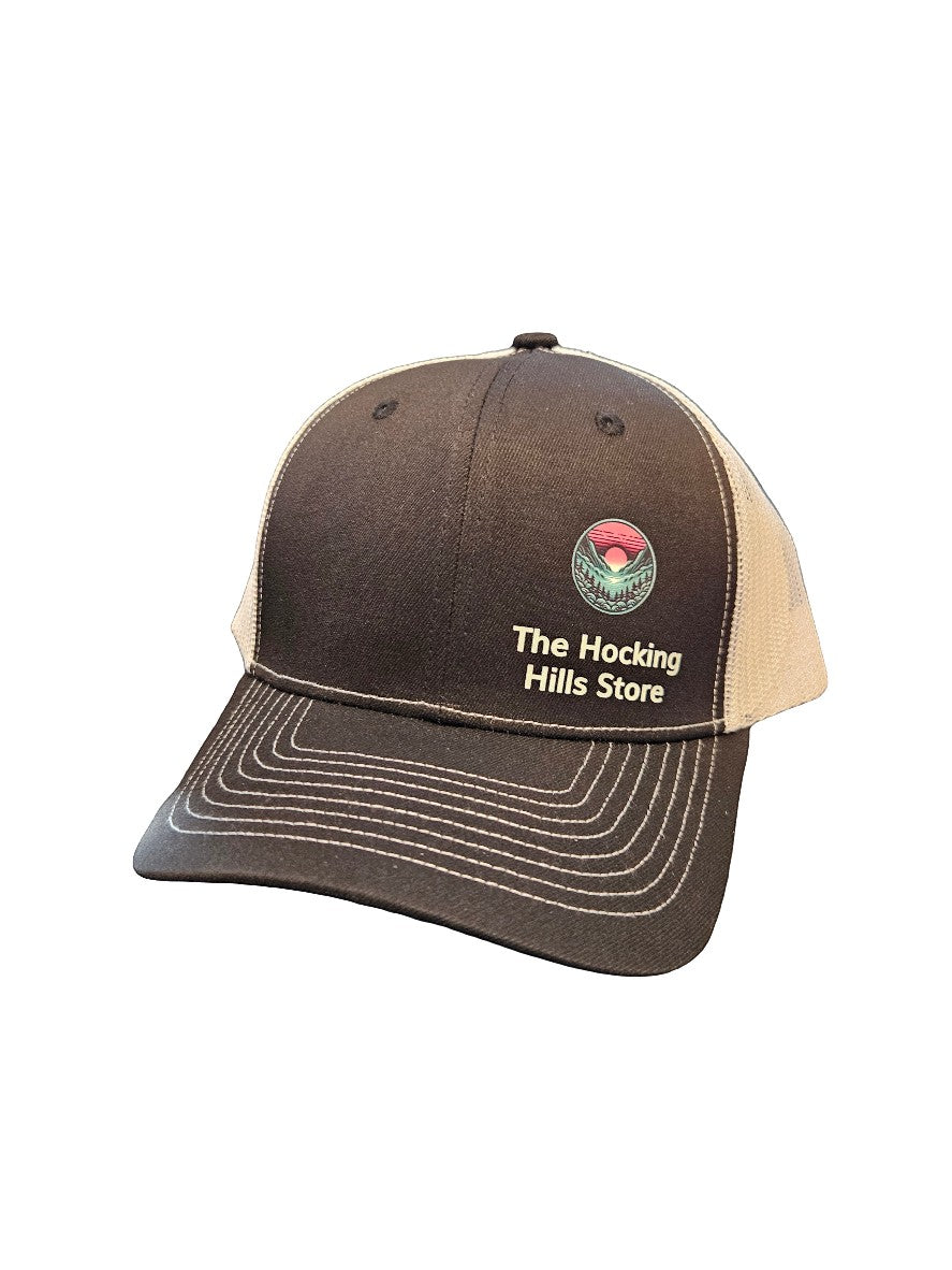 The Hocking Hills Store brown and tan trucker hat with embroidered logo, adjustable strap, and mesh back.