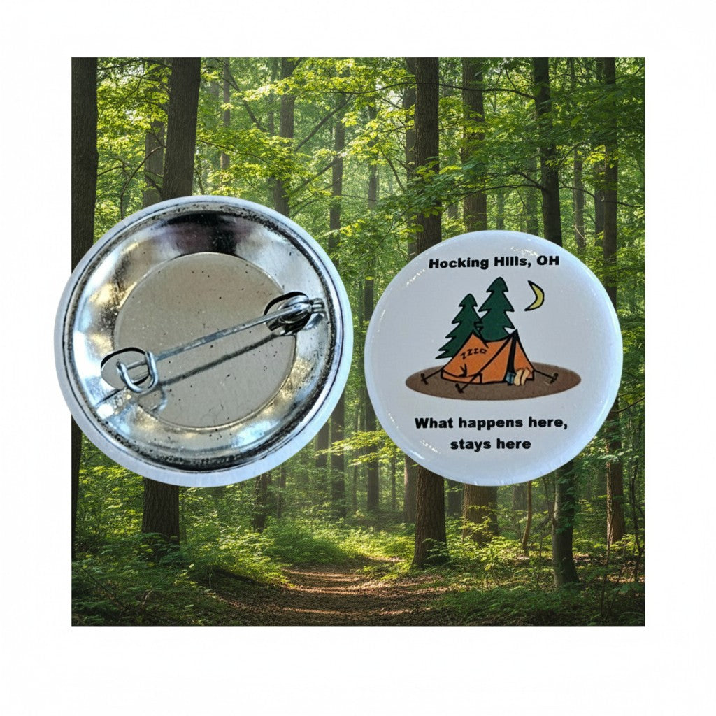 The Hocking Hills Store "What Happens Here Stays Here" camping button with a tent, trees, moon, and zzz text.