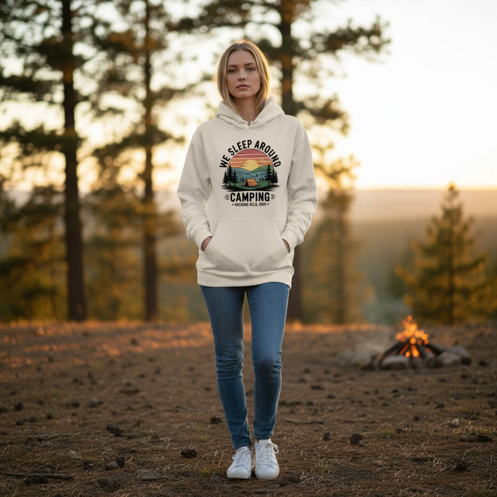 The Hocking Hills Store We Sleep Around camping graphic hoodie in beige, featuring a sunset, tent, and trees.