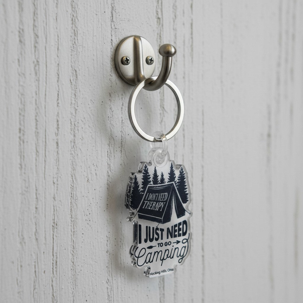 The Hocking Hills Store camping keychain with a tent, pine trees, and the quote 'I don't need therapy, I just need to go camping'.