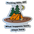 The Hocking Hills Store refrigerator magnet featuring a camping scene with an orange tent, trees, moon, and the text "What happens here, stays here."