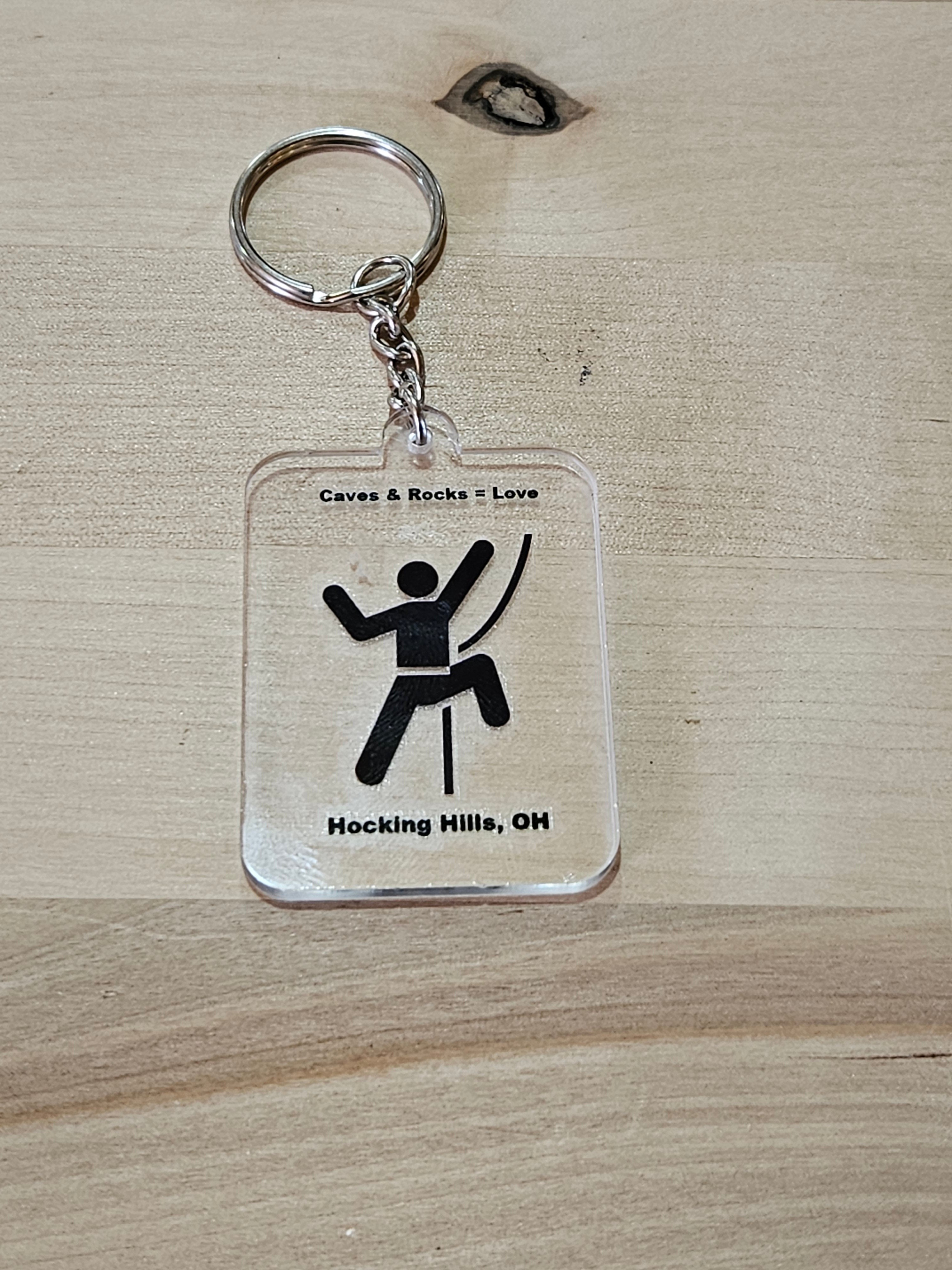The Hocking Hills Store keychain features a climber graphic and text 'Caves & Rocks = Love' and 'Hocking Hills, OH'.