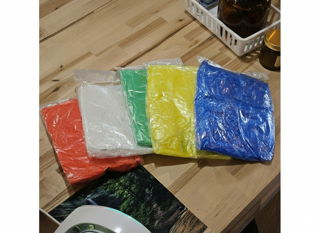 The Hocking Hills Store disposable emergency rain ponchos in red, white, green, yellow, and blue plastic packaging.