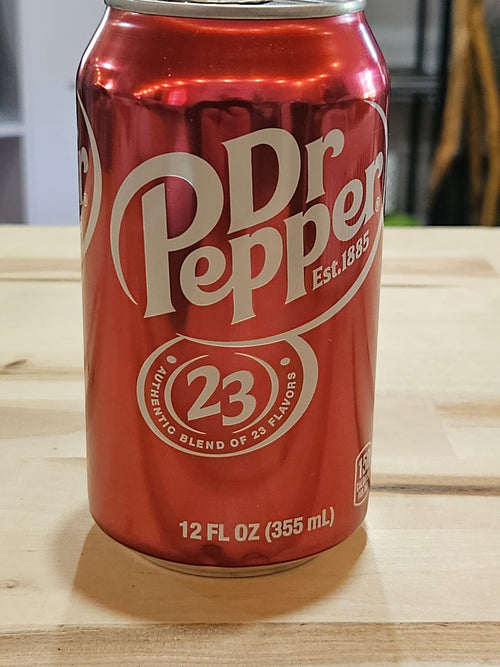 The Hocking Hills Store red Dr Pepper soda can featuring the 23 flavors logo on a wooden surface.