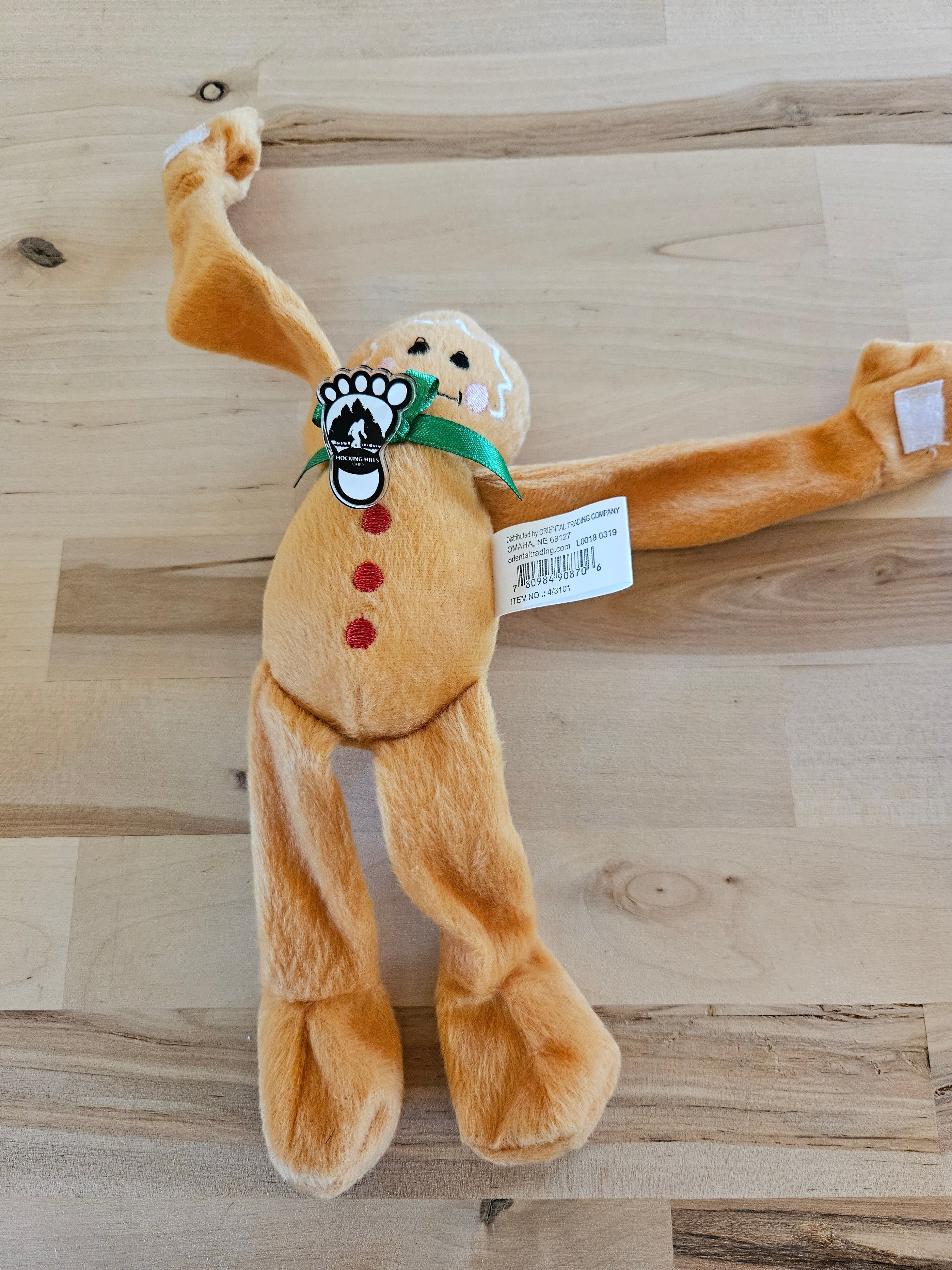 The Hocking Hills Store gingerbread plush toy with red button details and a green ribbon.