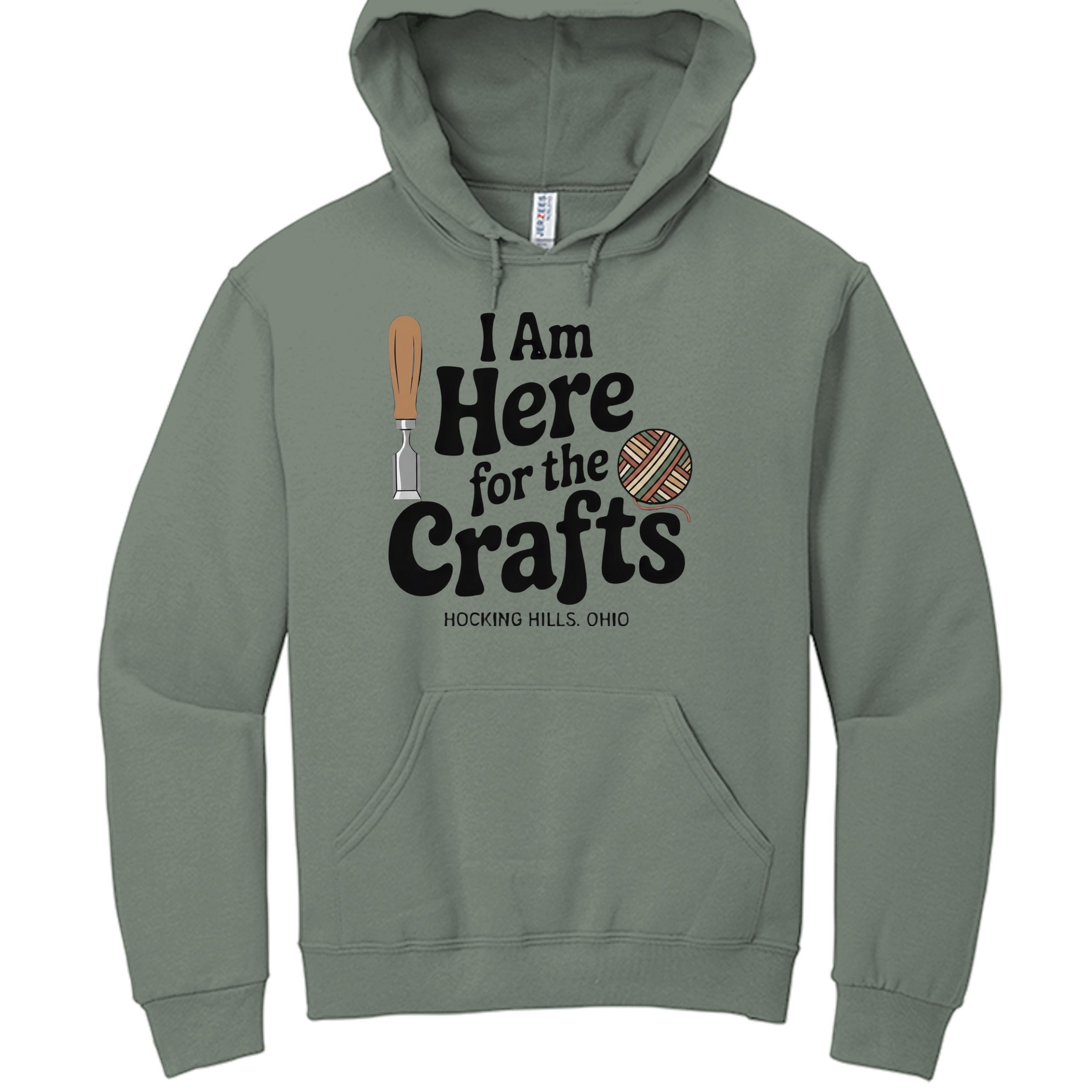 The Hocking Hills Store green pullover hoodie with "I Am Here for the Crafts" graphic, featuring a chisel and yarn ball.