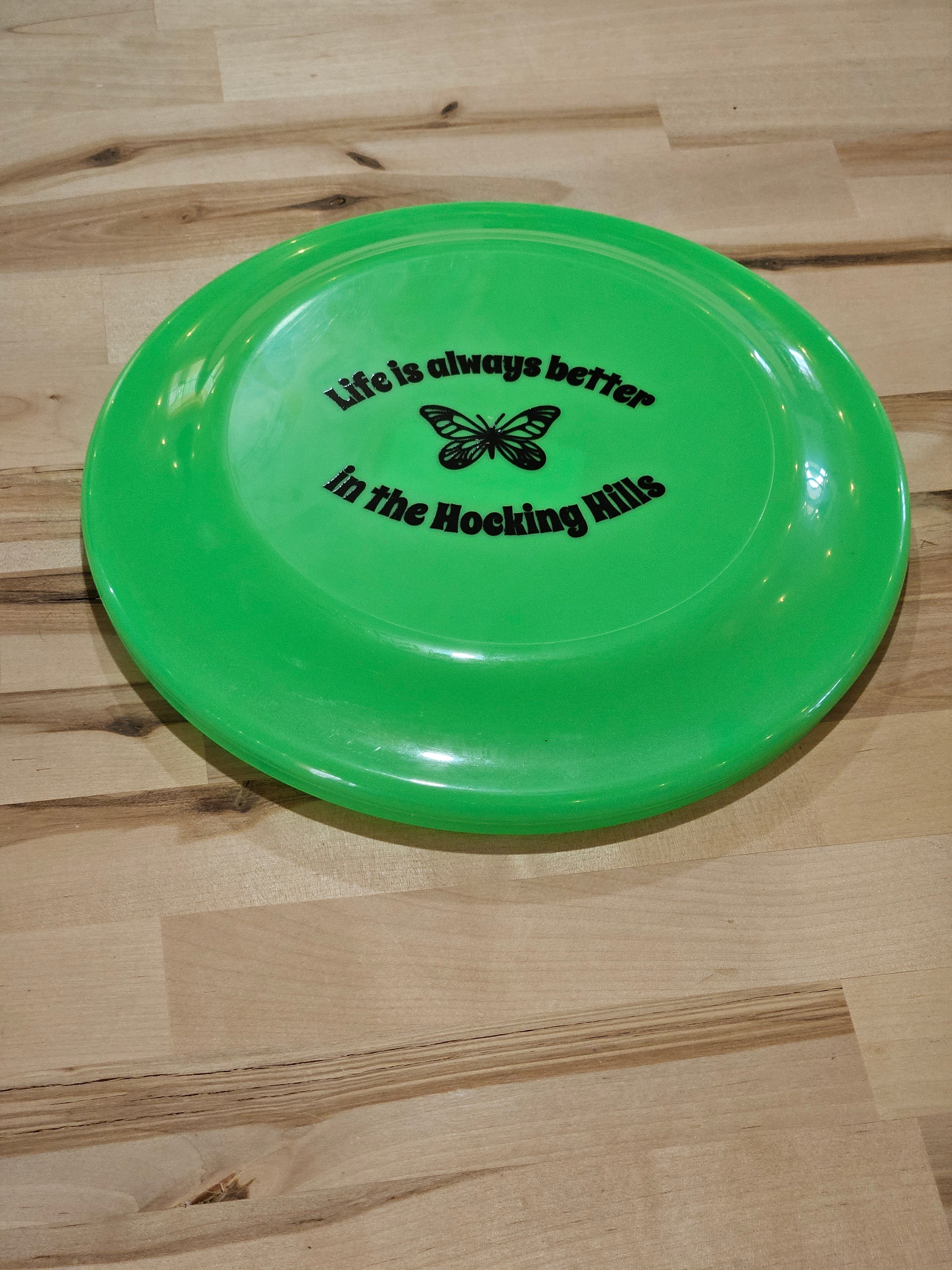 The Hocking Hills Store green frisbee with butterfly graphic and text "Life is always better in the Hocking Hills".