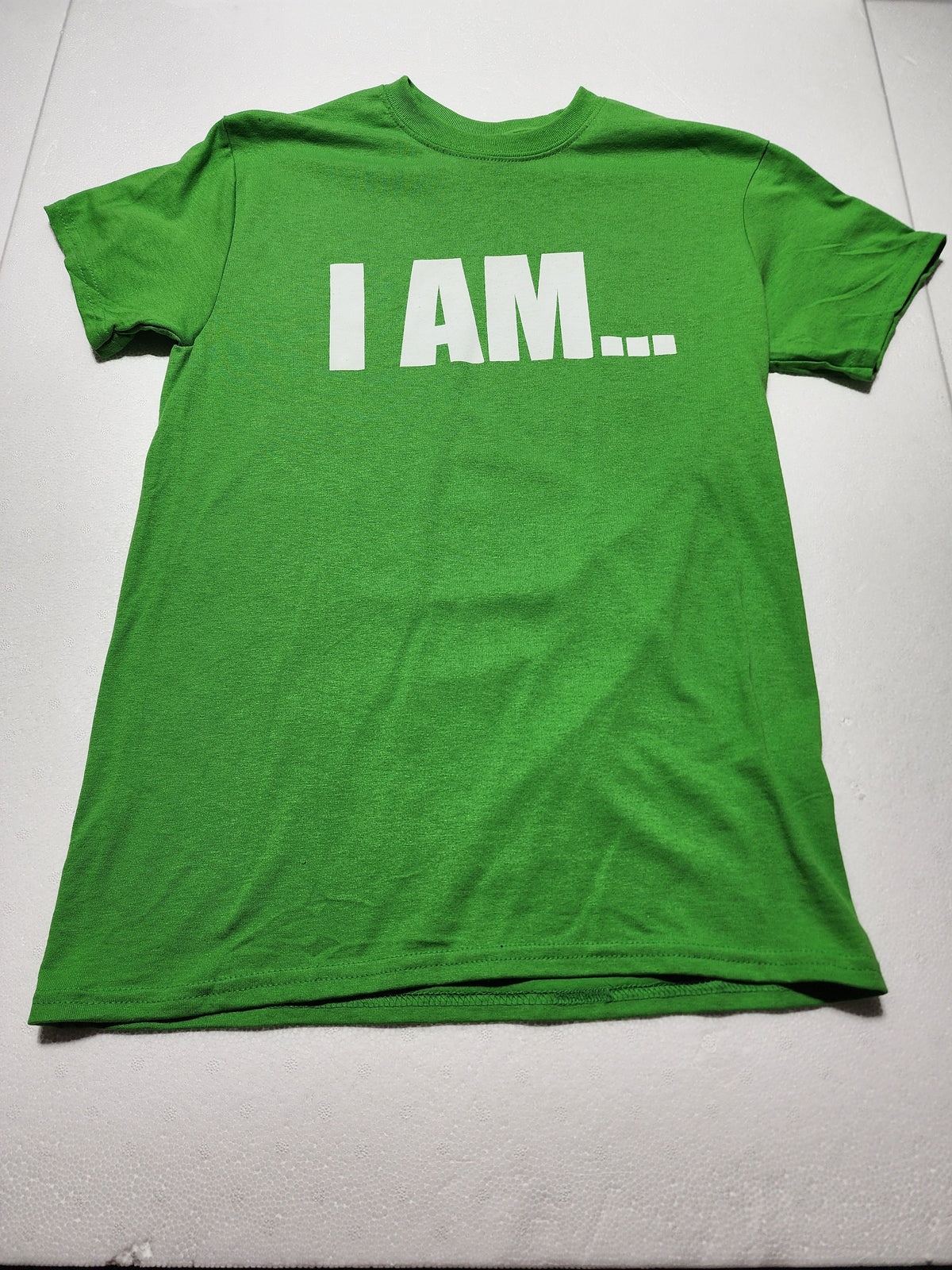 The Hocking Hills Store green I Am T-Shirt with white bold minimalist text on a soft cotton fabric.