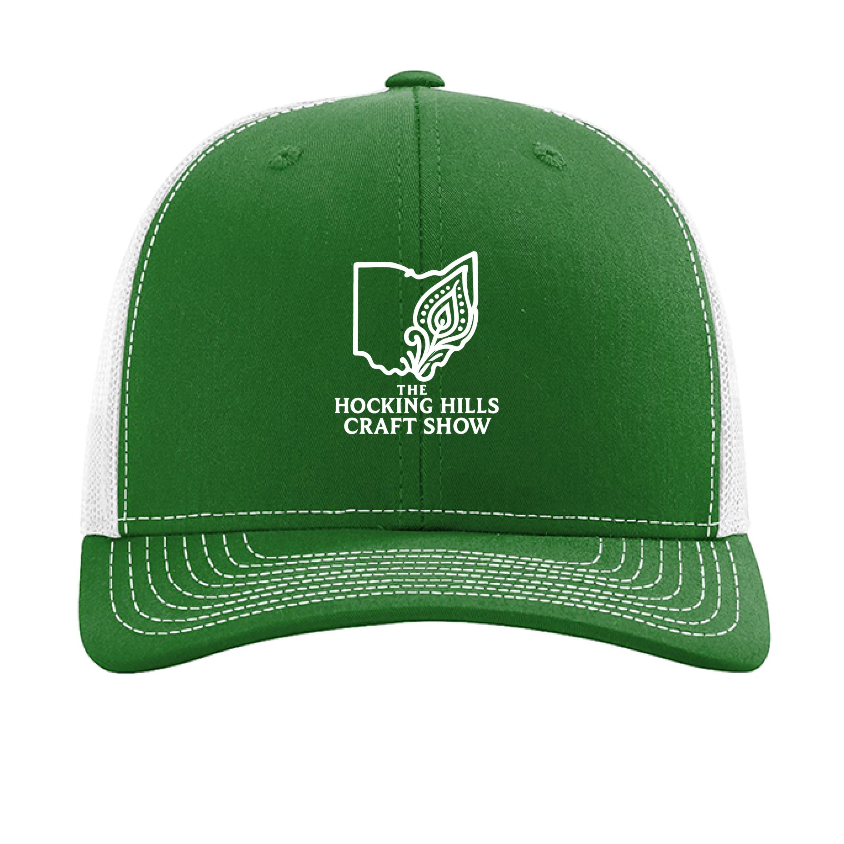 The Hocking Hills Store green and white trucker hat with Hocking Hills Craft Show logo. Cotton/polyester front, mesh back.