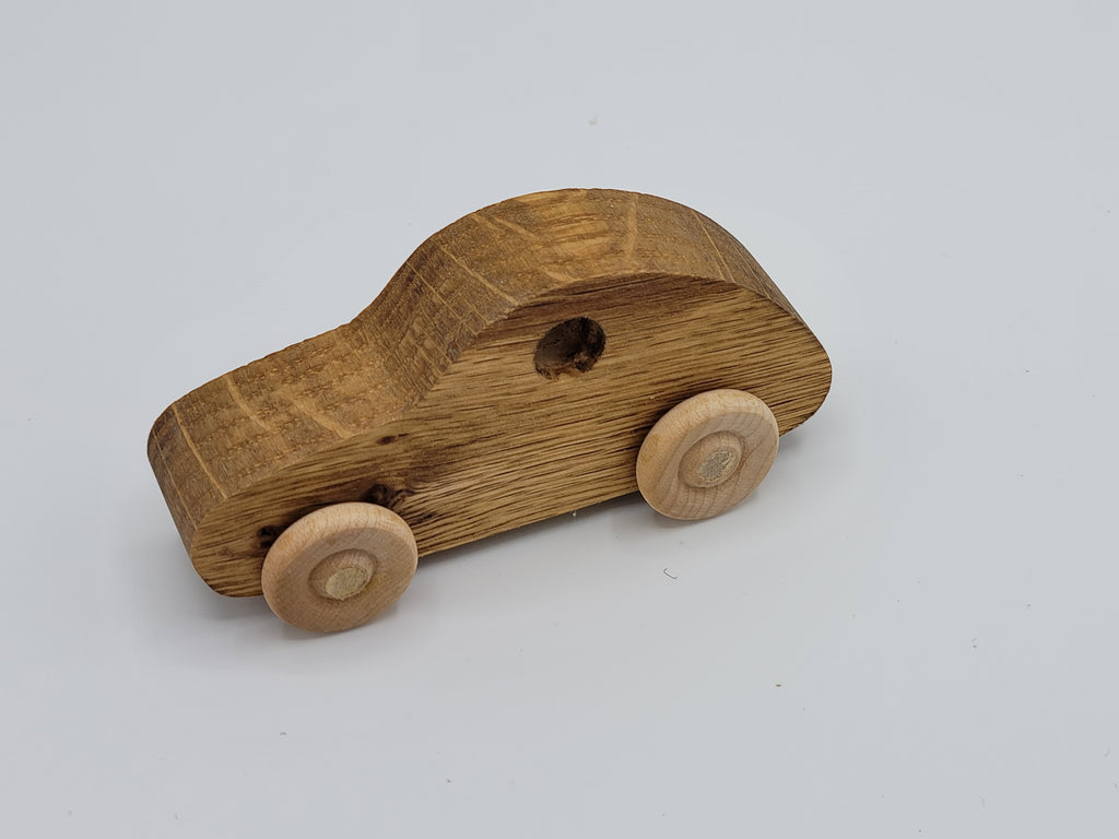 The Hocking Hills Store handmade wooden toy car, natural wood finish, simple design with wooden wheels.