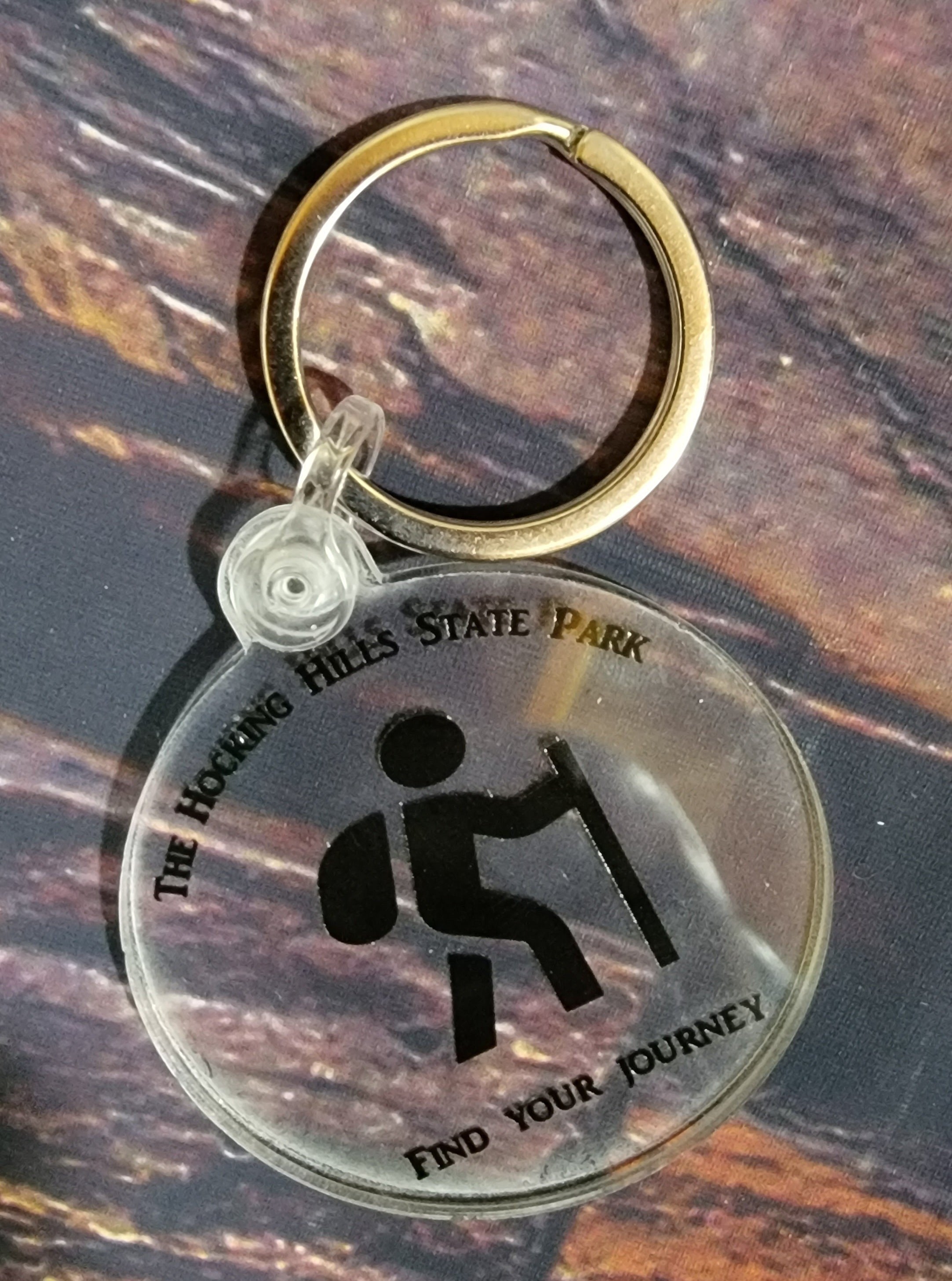 The Hocking Hills Store keychain with a hiker graphic and the words "find your journey".