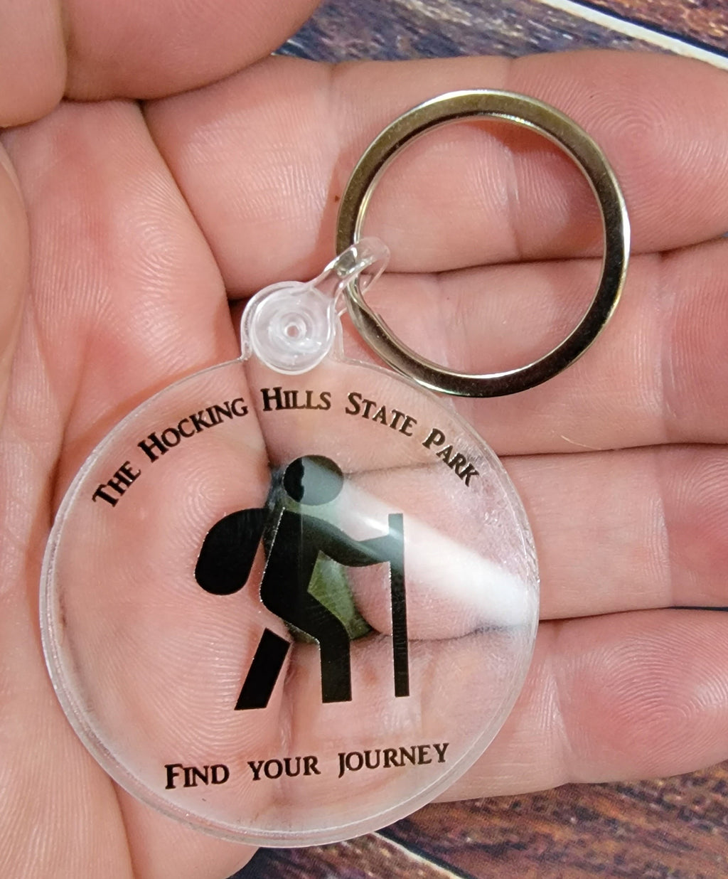 The Hocking Hills Store keychain with a black and white hiker graphic and the words "Find Your Journey".