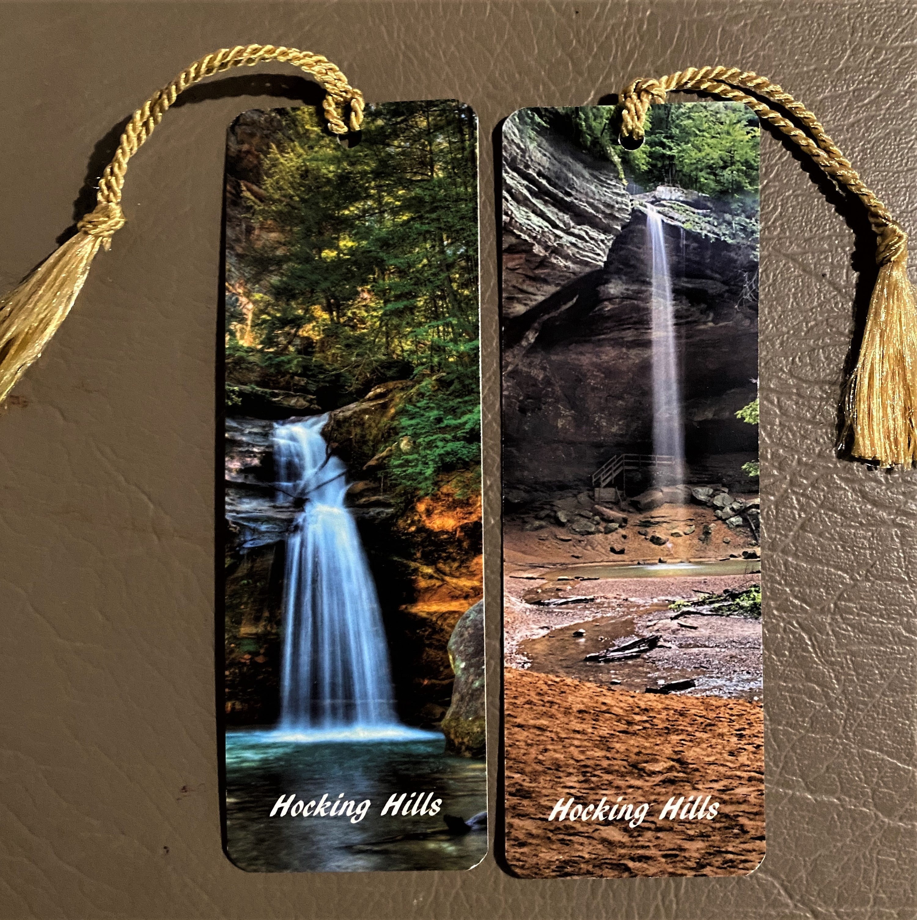 The Hocking Hills Store Hocking Hills picture bookmarks featuring waterfalls and forest scenes. Each bookmark has a gold tassel.