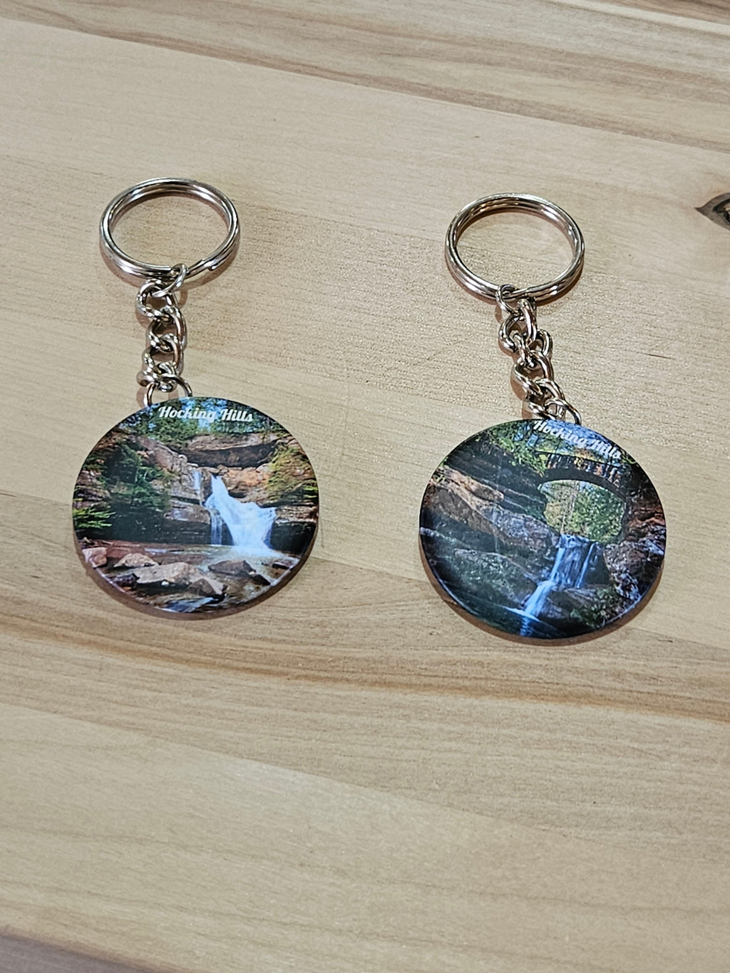 The Hocking Hills Store keychain features a scenic waterfall image from Hocking Hills, Ohio, with a silver metal ring and chain.