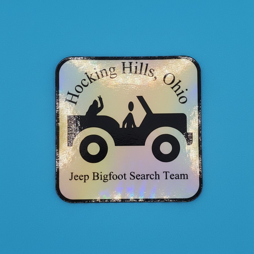 The Hocking Hills Store holographic bumper sticker featuring a Jeep silhouette with two figures and "Jeep Bigfoot Search Team" text.