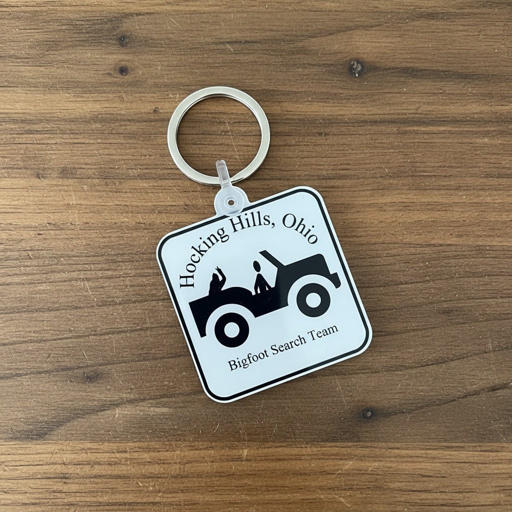 The Hocking Hills Store Jeep Bigfoot Search Team keychain with a jeep graphic and Hocking Hills, Ohio text.