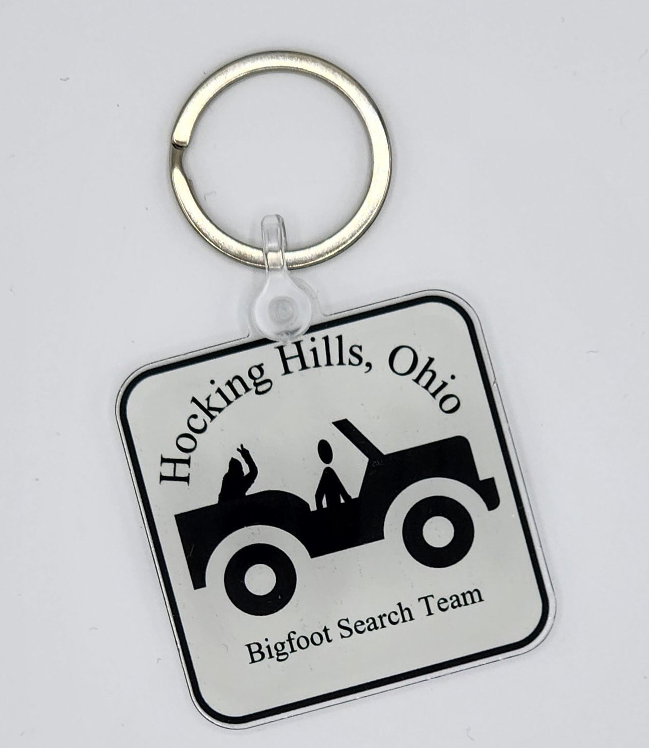 The Hocking Hills Store Jeep Bigfoot Search Team keychain with a jeep graphic and text.