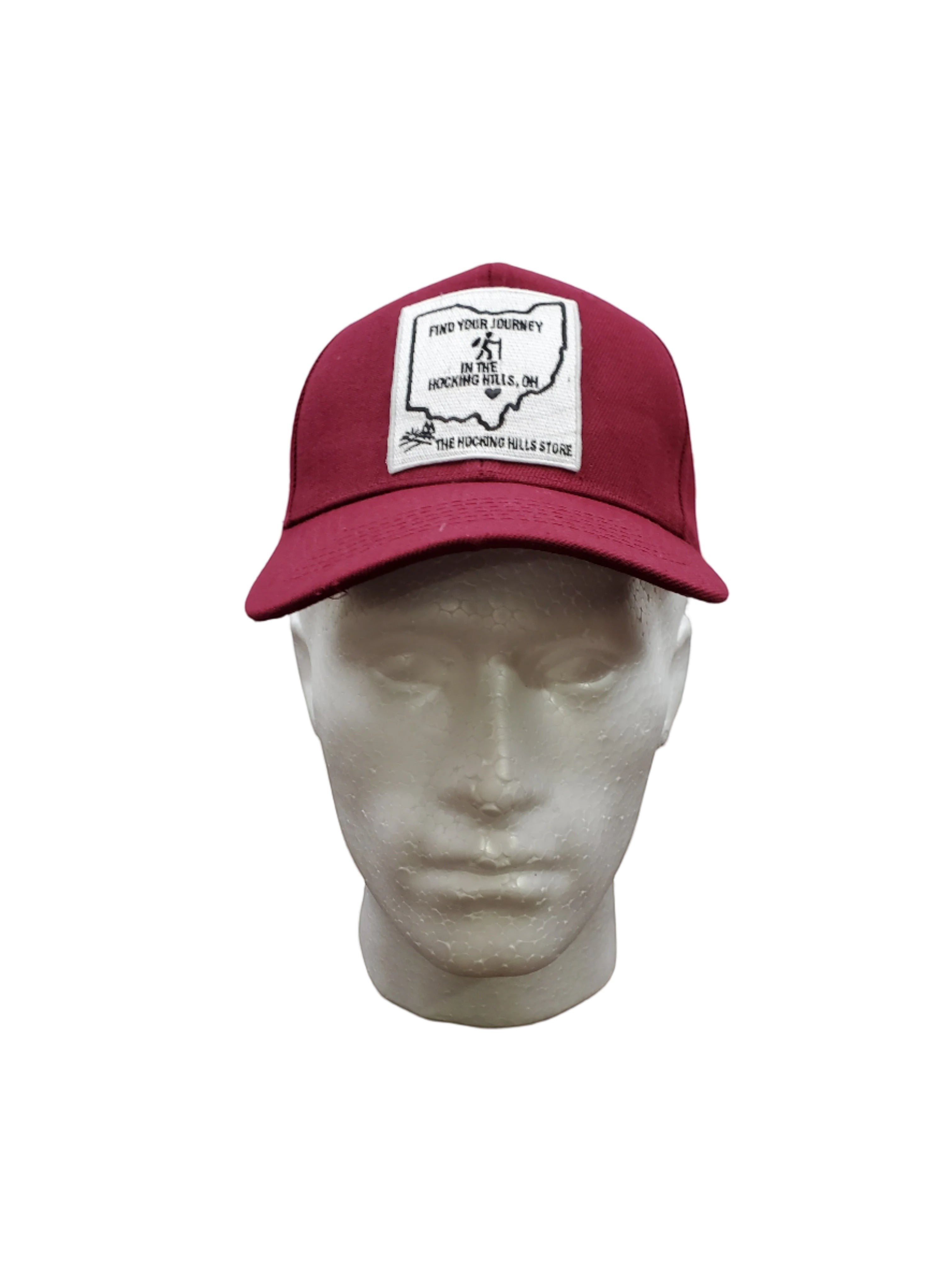 The Hocking Hills Store maroon baseball cap with a patch featuring an outline of Ohio and the text "Find Your Journey in the Hocking Hills, OH".