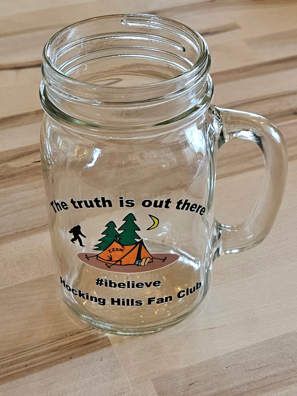 The Hocking Hills Store clear glass mason jar mug with camping graphic and text "the truth is out there #ibelieve Hocking Hills Fan Club".