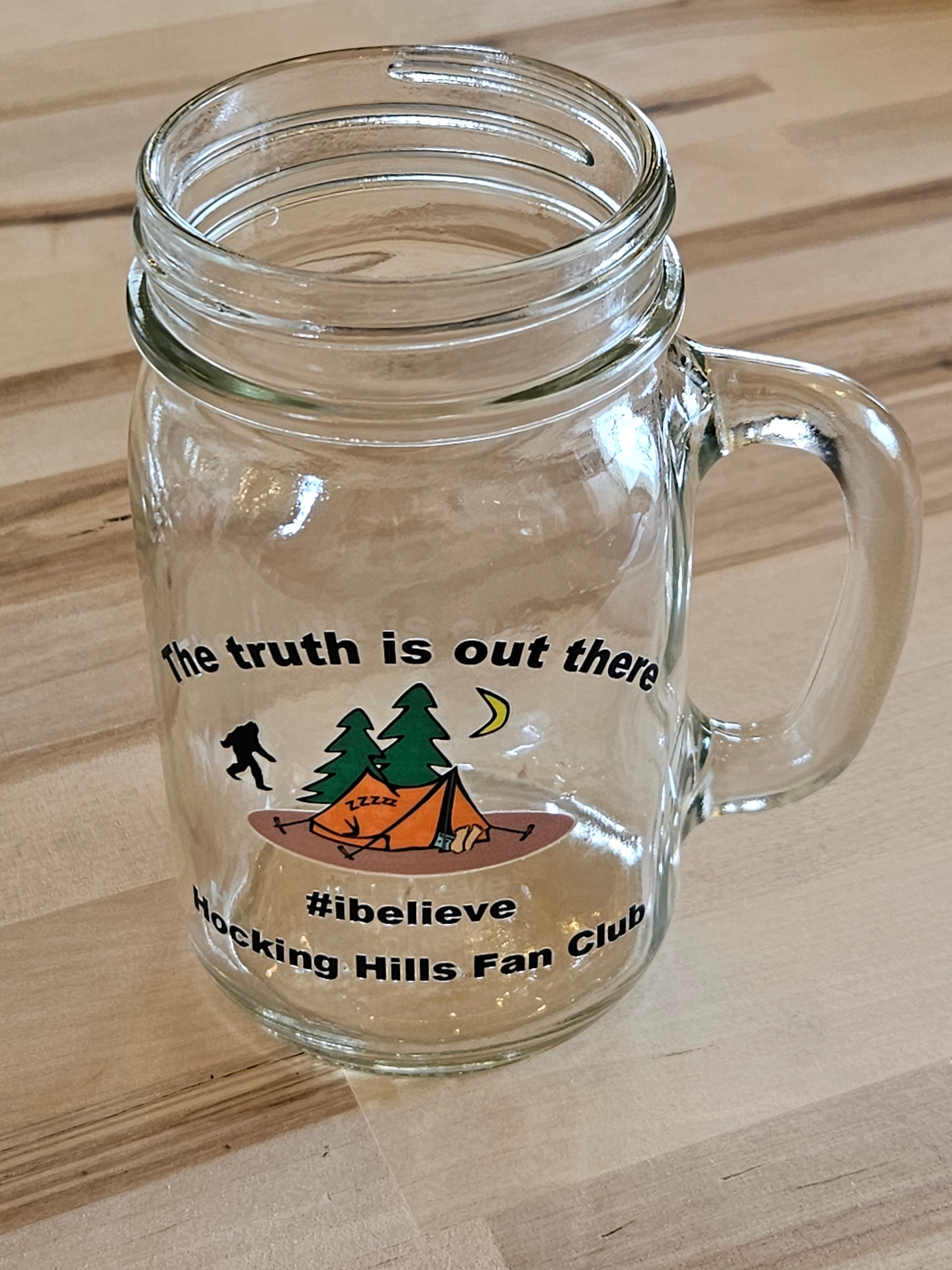 The Hocking Hills Store clear glass mason jar mug with camping graphic and text "the truth is out there #ibelieve Hocking Hills Fan Club".