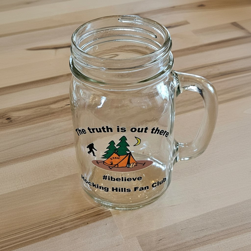 The Hocking Hills Store clear glass mason jar mug with camping graphic and text "the truth is out there #ibelieve Hocking Hills Fan Club".