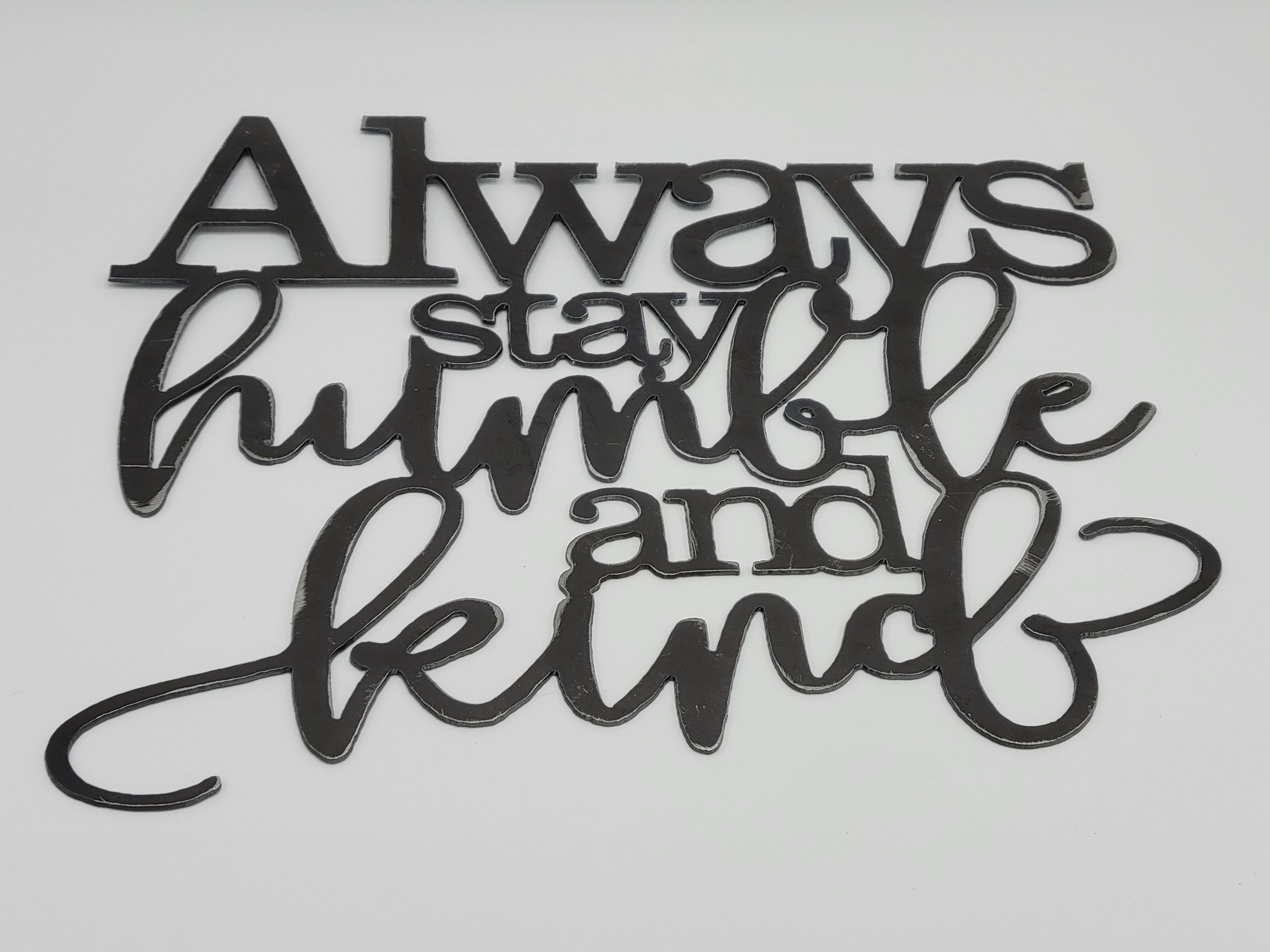 The Hocking Hills Store black metal wall art with the phrase 'Always stay humble and kind' in decorative script.
