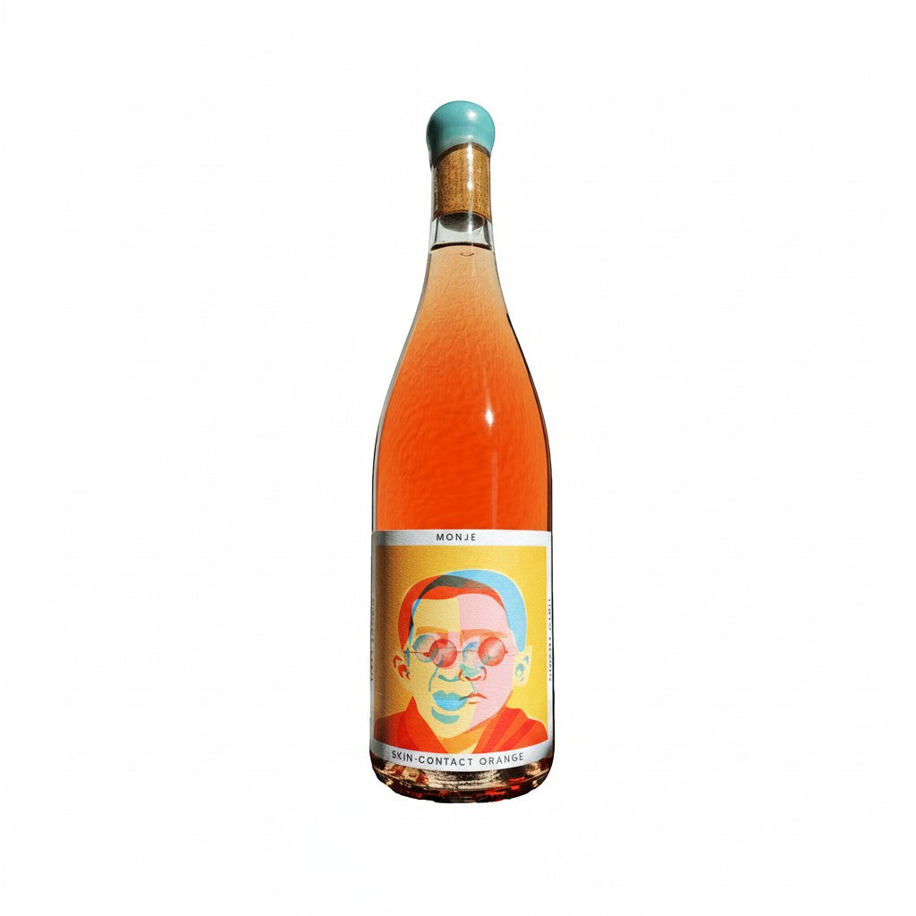 The Hocking Hills Store Monje 7-day skin-contact orange wine in a clear bottle with a colourful label featuring a portrait.