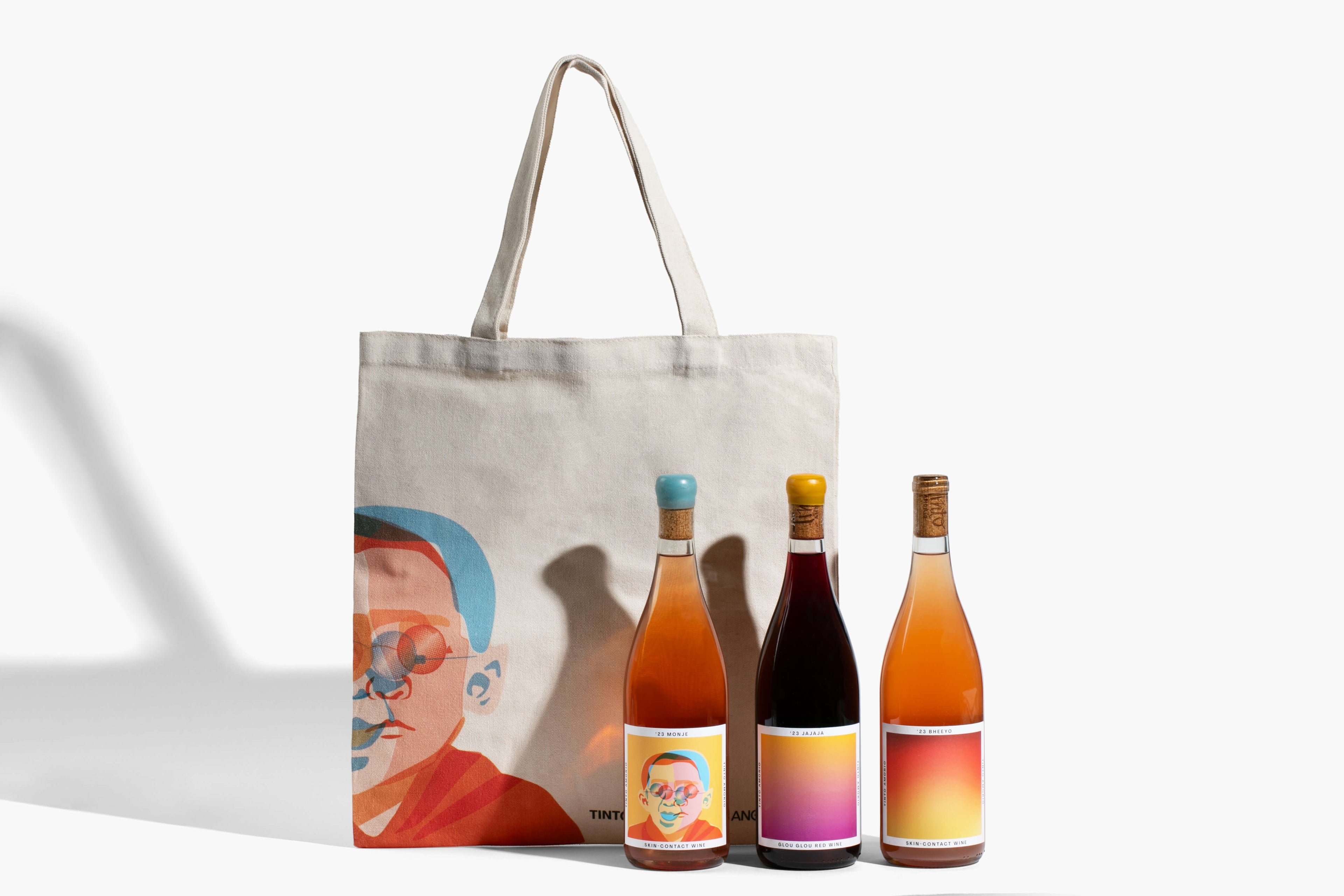 The Hocking Hills Store Natural Wine Essential Bundle: 3 bottles of wine (red, orange, rosé) and a canvas tote bag with a graphic print.