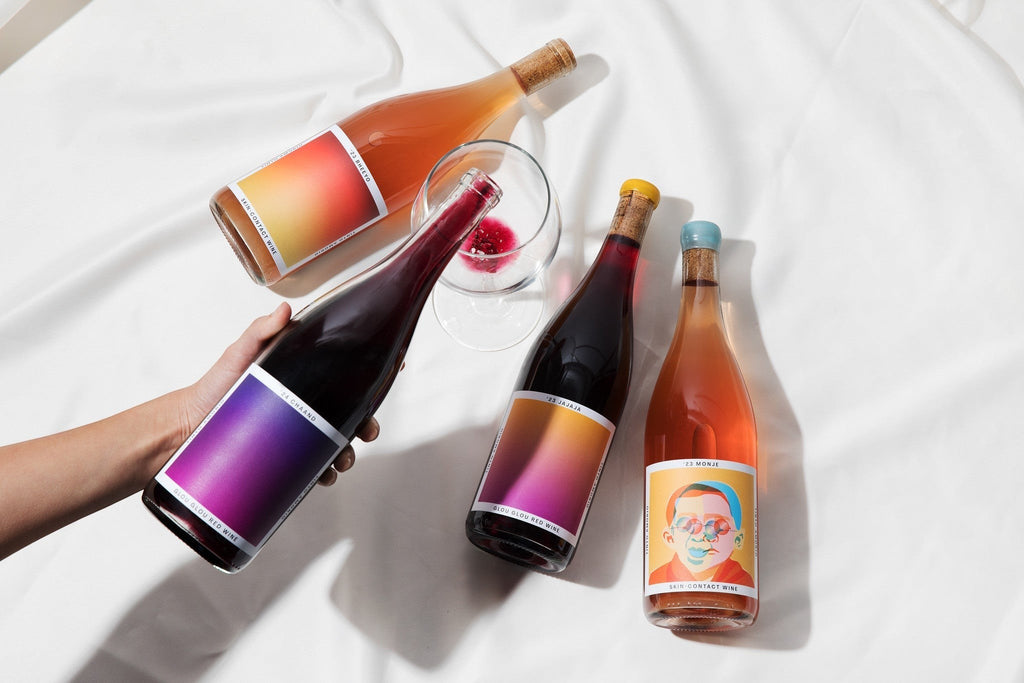 The Hocking Hills Store natural wine sampler featuring four bottles: Chaand red wine, Jajaja red wine, Bheeyo orange wine, and Monje orange wine.