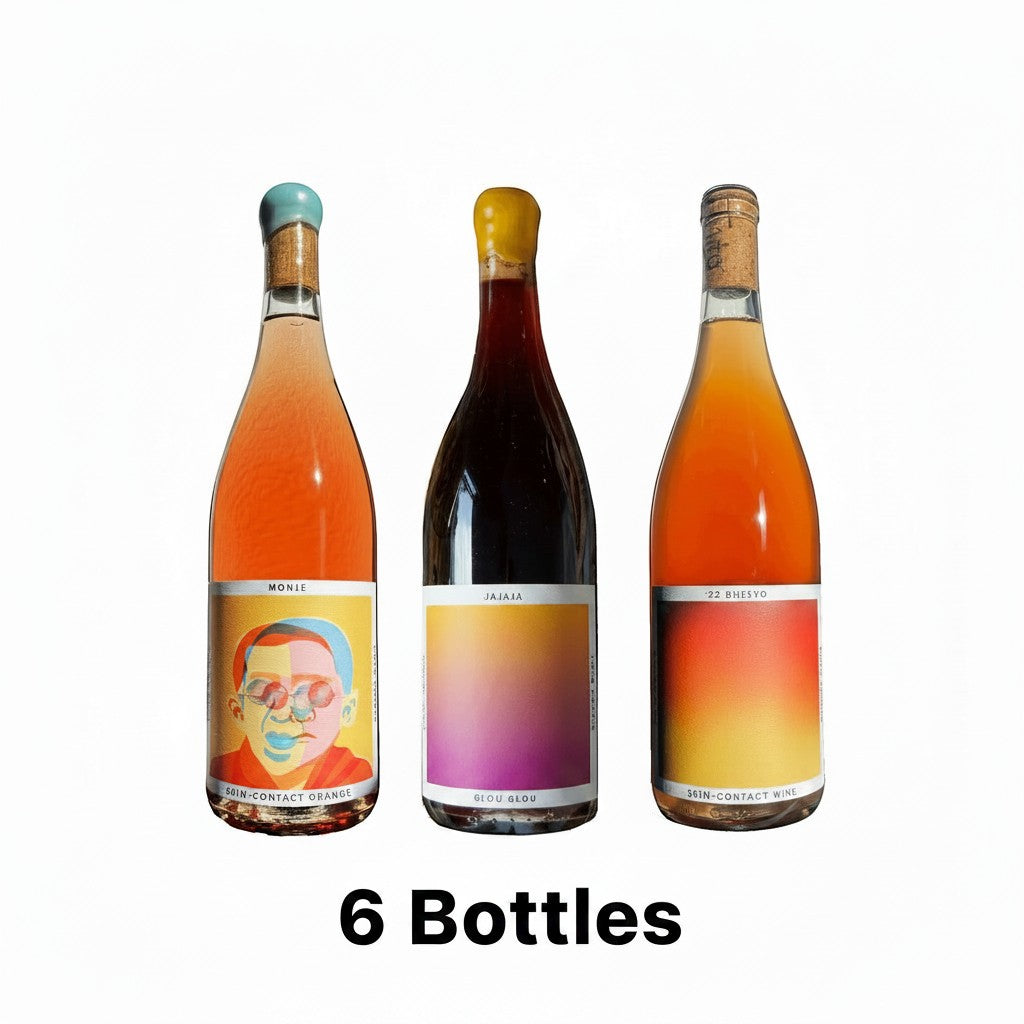 The Hocking Hills Store natural wine sampler set featuring three bottles: Monje Skin-Contact Orange, Jajaja Glou Glou Red, and Bheeyo Orange Wine.