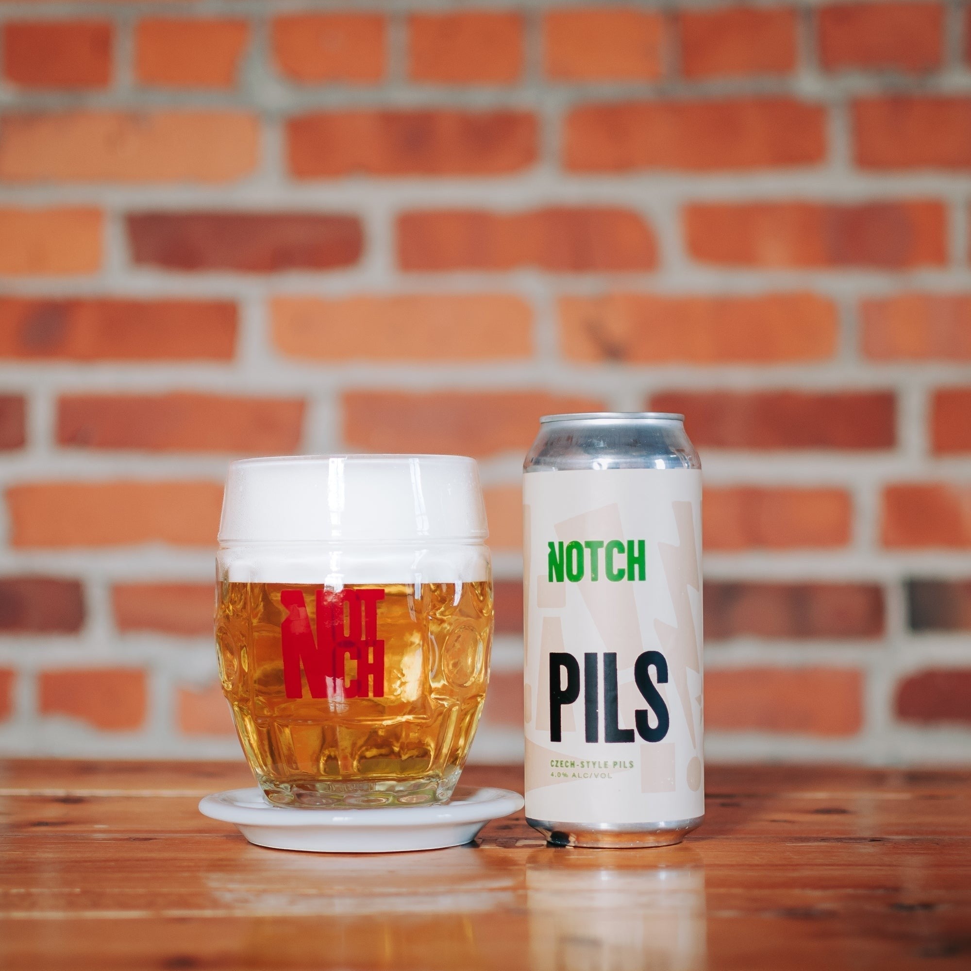 The Hocking Hills Store's Notch Session Pils beer can and glass. Crisp, herbal, hoppy Czech-style pilsner with 4.0% ABV.