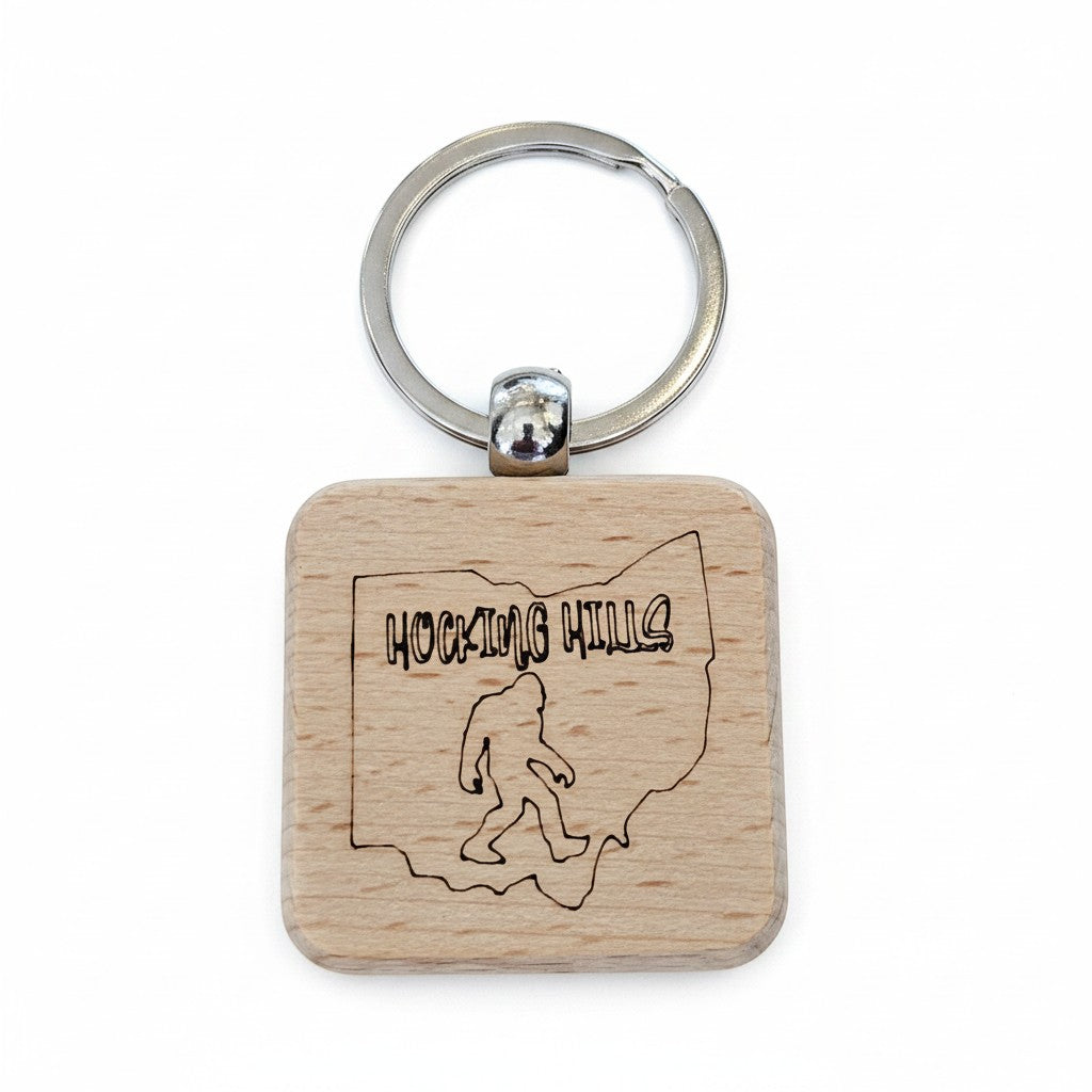 The Hocking Hills Store wooden keychain featuring a laser-engraved outline of Ohio with 'Hocking Hills' text and a Bigfoot silhouette.