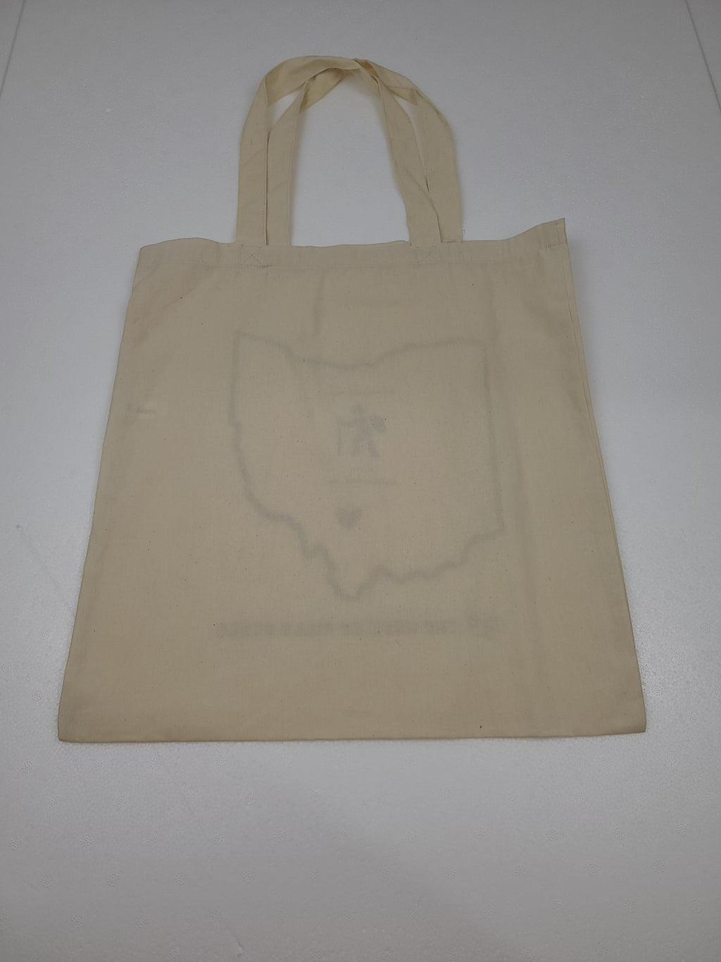 The Hocking Hills Store natural canvas tote bag featuring an outline of Ohio with a heart and text. Durable and spacious for travel.