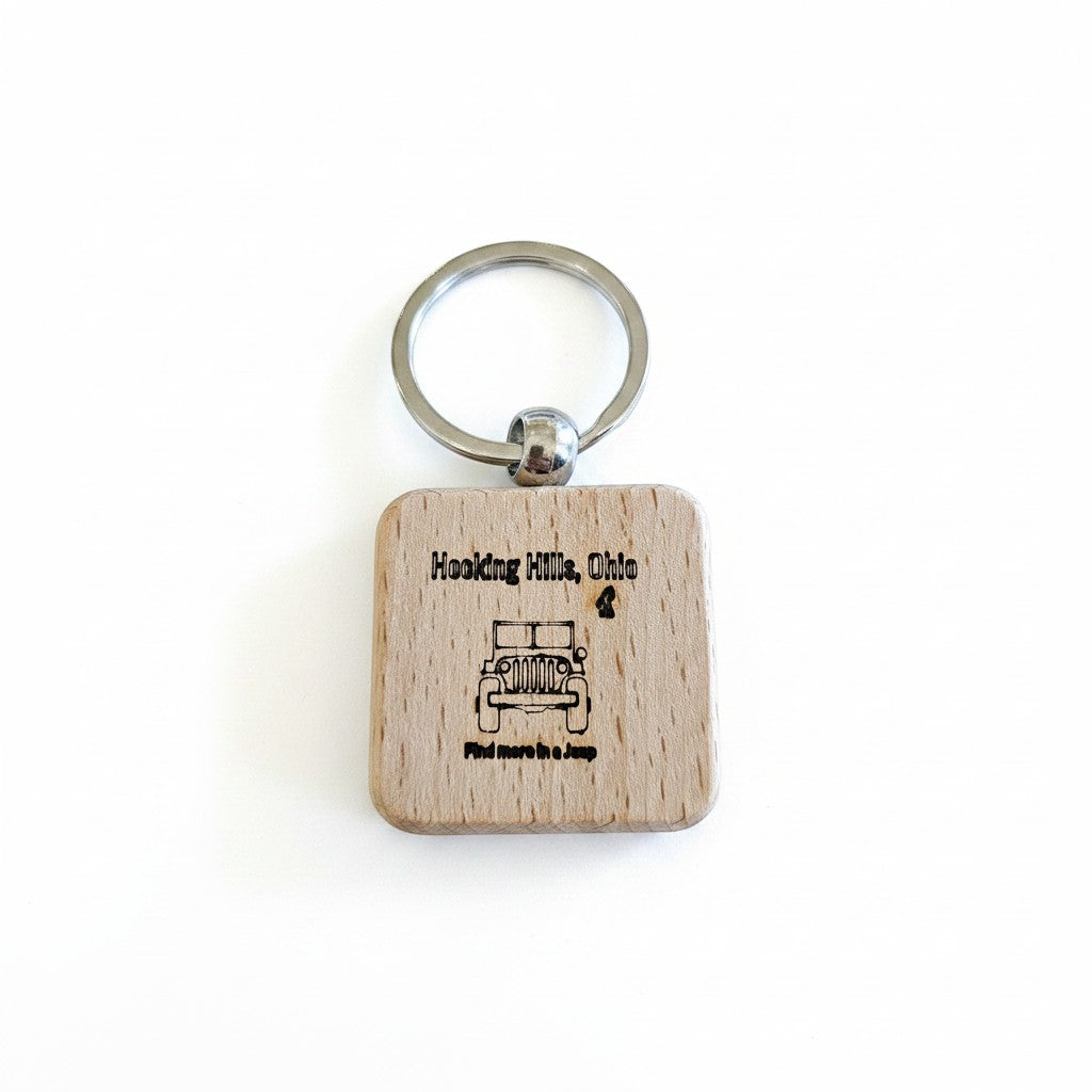 The Hocking Hills Store wooden keychain laser engraved with a Jeep and text 'Hocking Hills, Ohio' and 'Find more in a Jeep'.