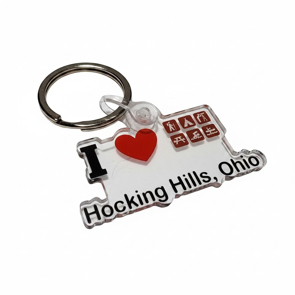 The Hocking Hills Store keychain shaped like Ohio, featuring 'I Love Hocking Hills, Ohio' text, a red heart, and icons for camping, hiking, and canoeing.