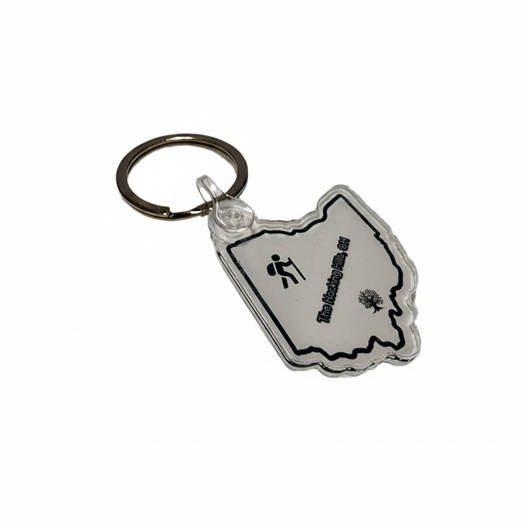 The Hocking Hills Store Ohio keychain in the shape of Ohio, featuring a hiker icon and tree graphic.