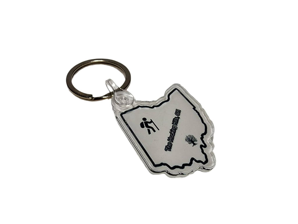 The Hocking Hills Store Ohio keychain in the shape of Ohio, featuring a hiker icon and a tree graphic.