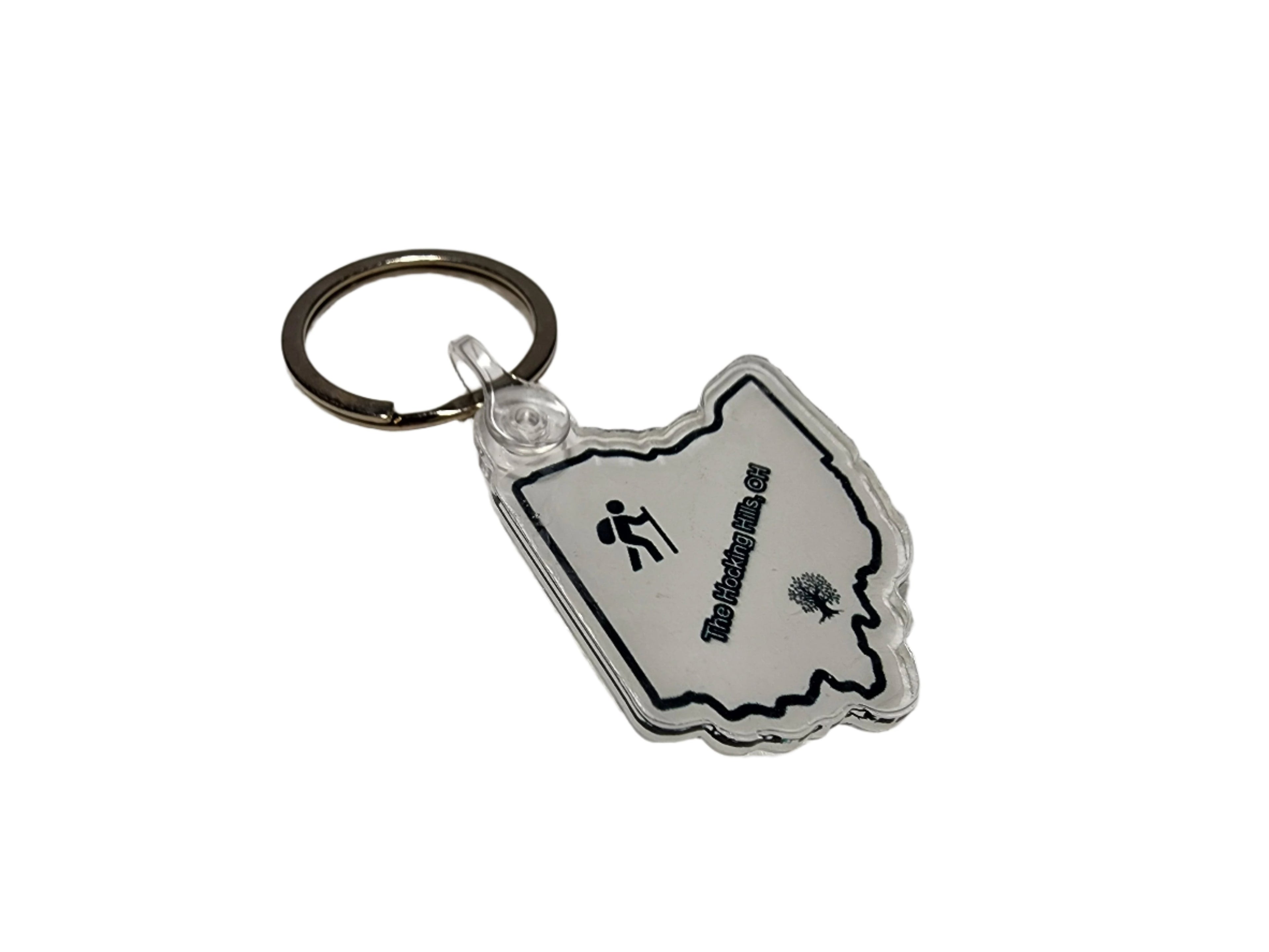 The Hocking Hills Store Ohio keychain in the shape of Ohio, featuring a hiker icon and a tree graphic.