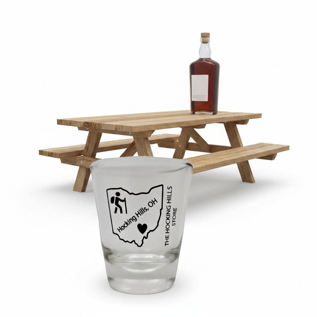 The Hocking Hills Store Ohio shot glass featuring a hiker icon and "Hocking Hills, OH" text. Clear glass.