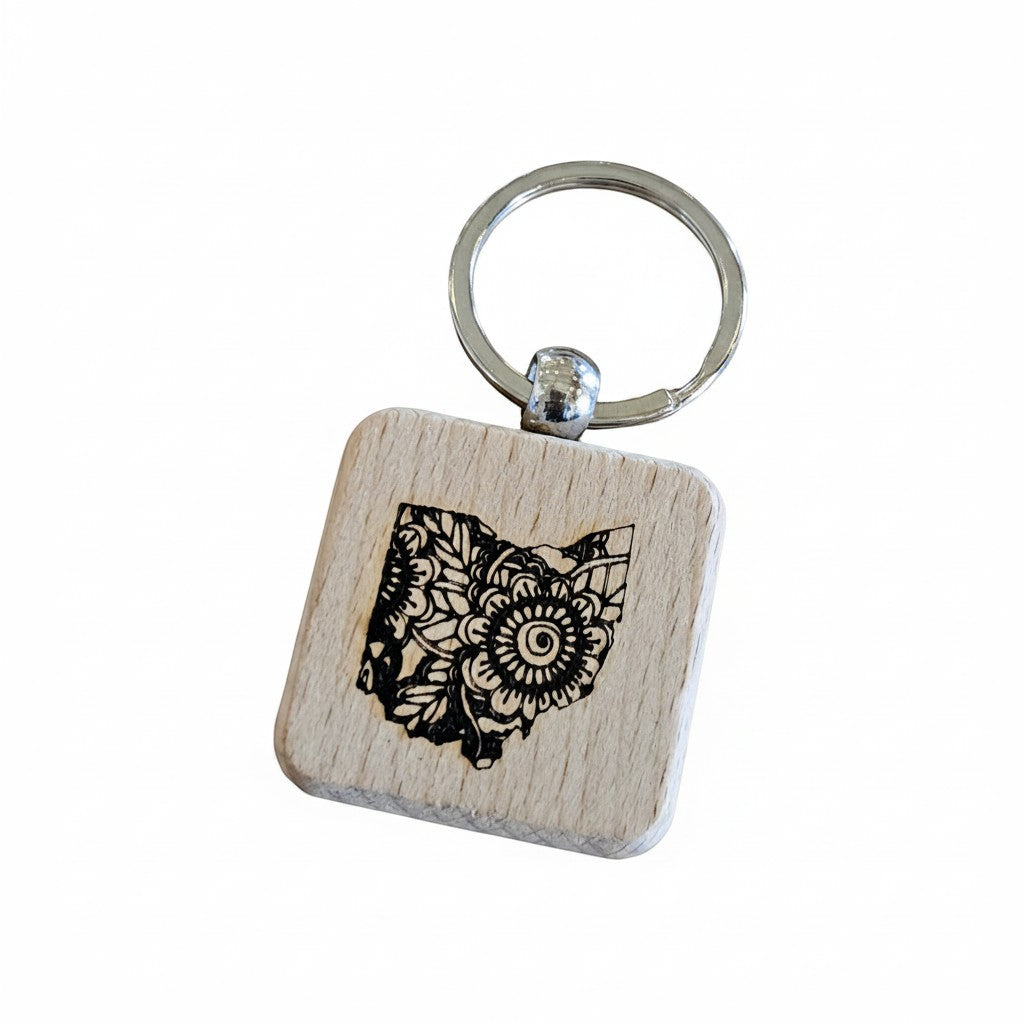 The Hocking Hills Store wooden keychain featuring a laser-engraved Ohio map with a floral paisley design.