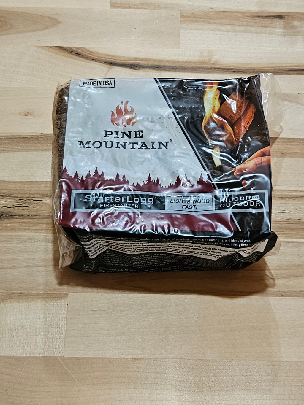 The Hocking Hills Store Pine Mountain Starter Log in plastic packaging for indoor and outdoor fire starting