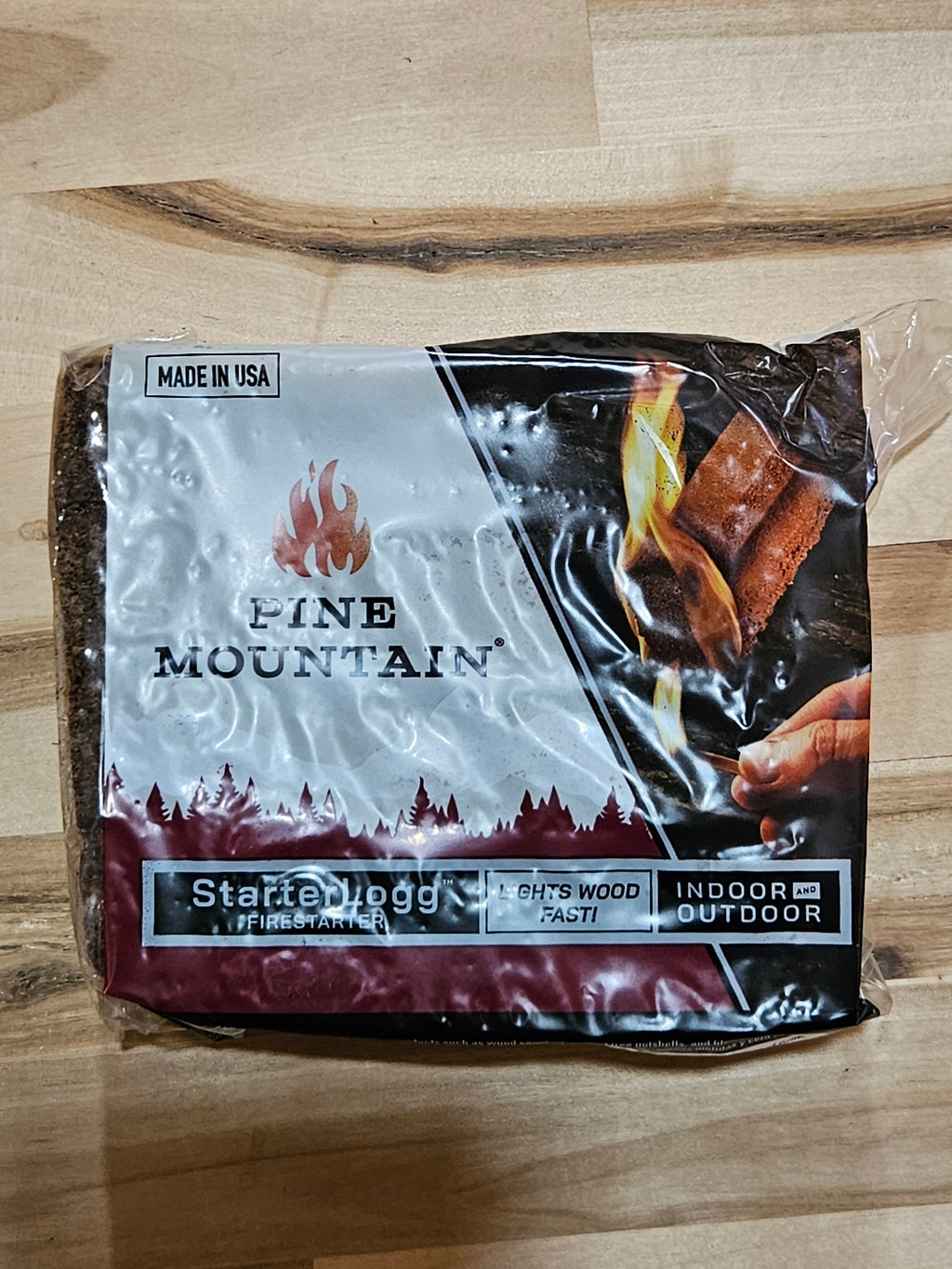 The Hocking Hills Store Pine Mountain Starter Log in plastic packaging for indoor and outdoor fire starting
