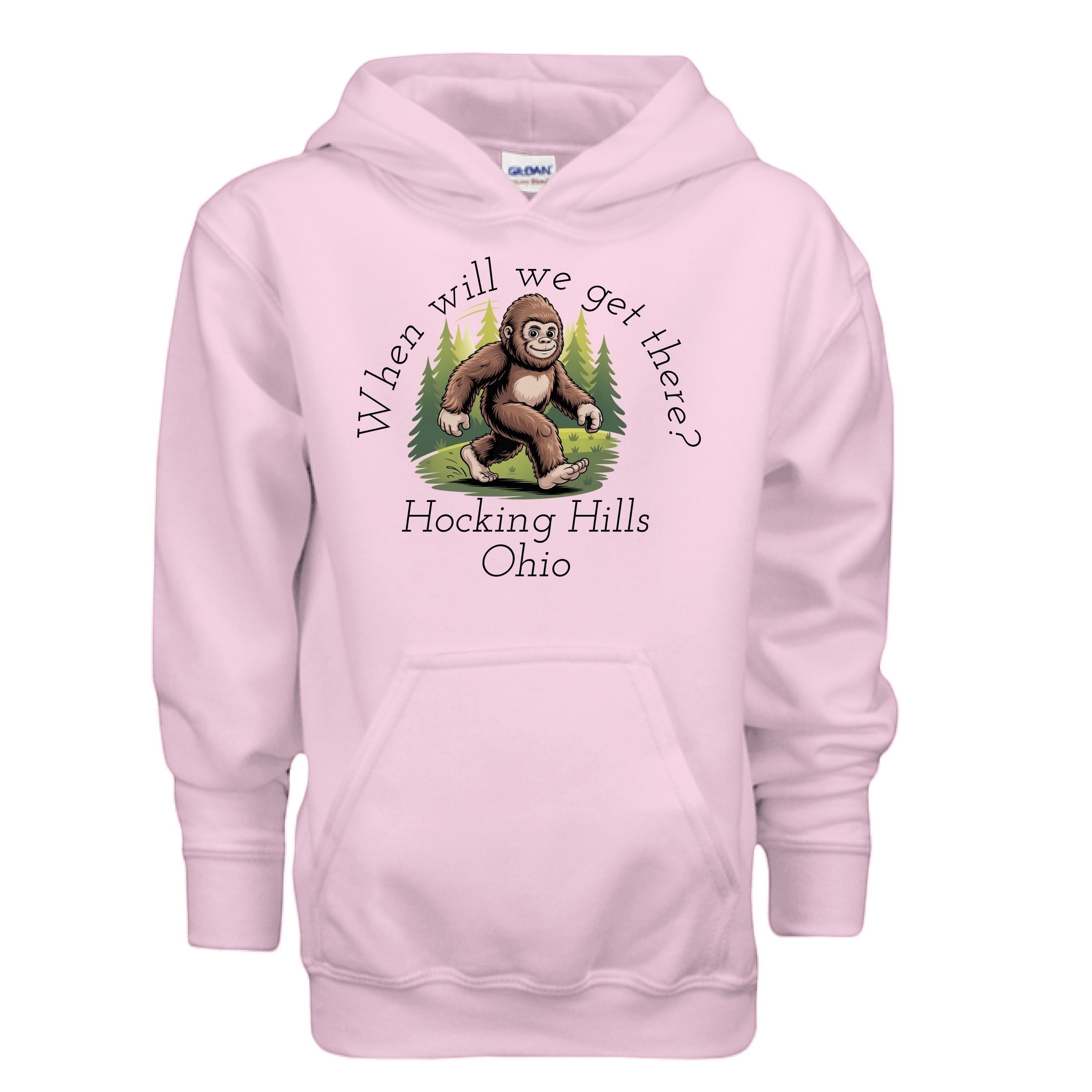 The Hocking Hills Store pink youth hoodie with a Bigfoot graphic and "When Will We Get There? Hocking Hills Ohio" text.