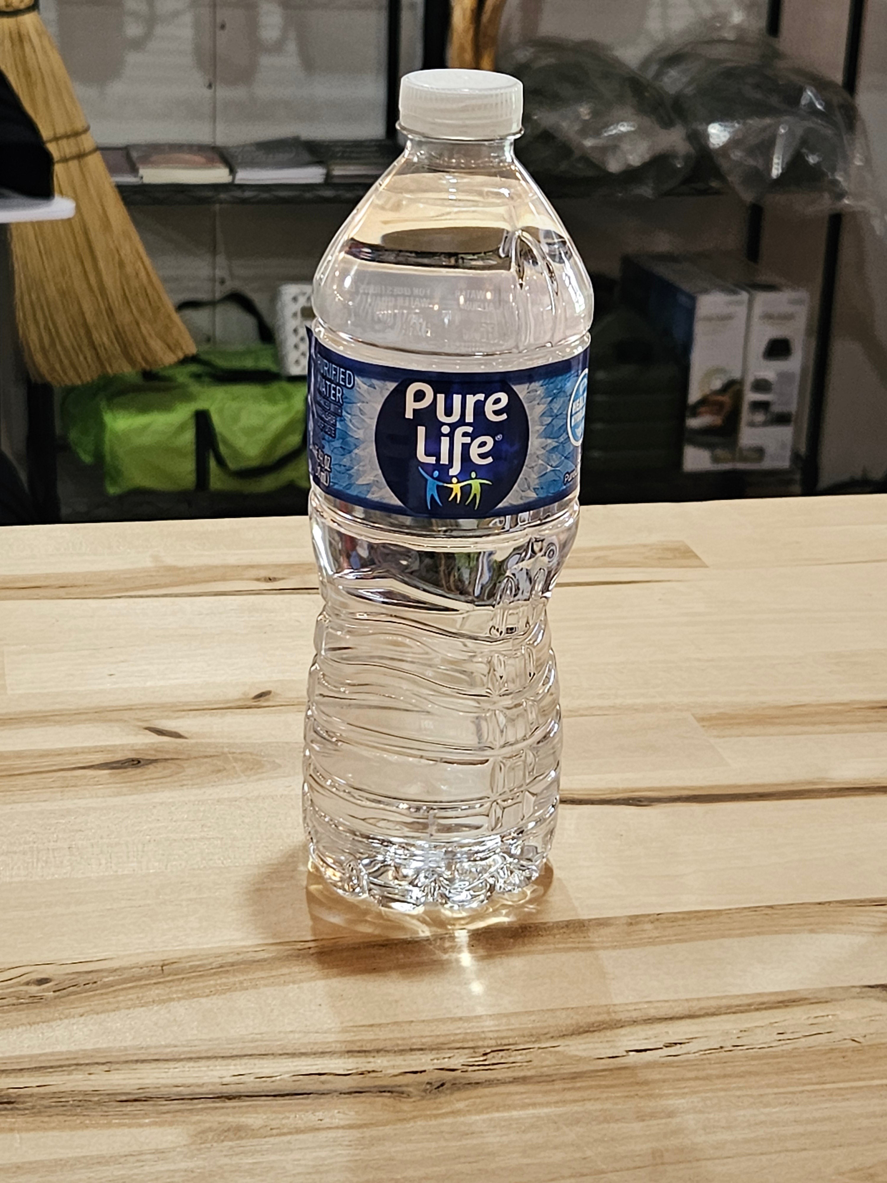 The Hocking Hills Store Pure Life bottled water on a light wooden table for refreshing hydration.