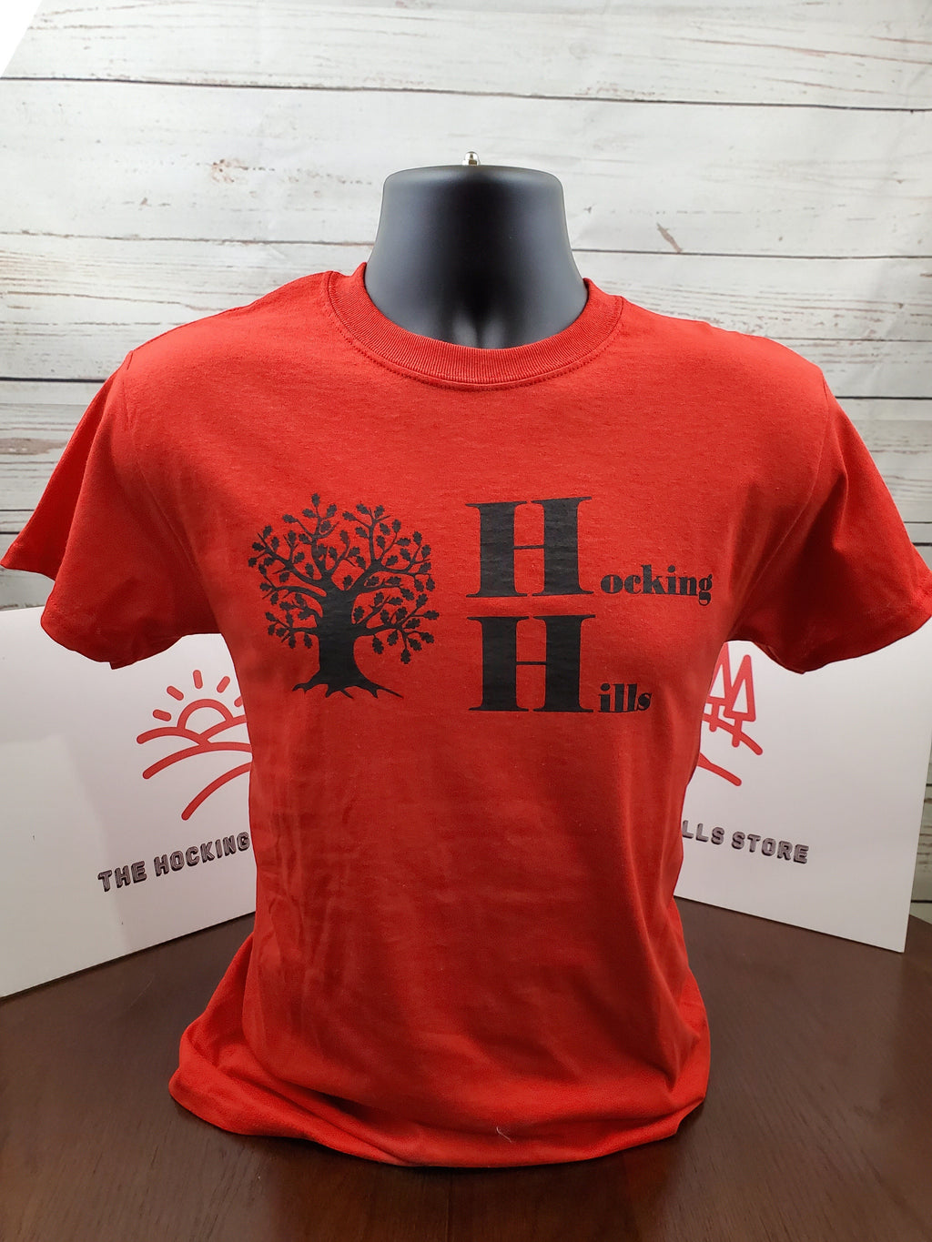 The Hocking Hills Store red cotton t-shirt with black tree and Hocking Hills logo. Short sleeves, crew neck.
